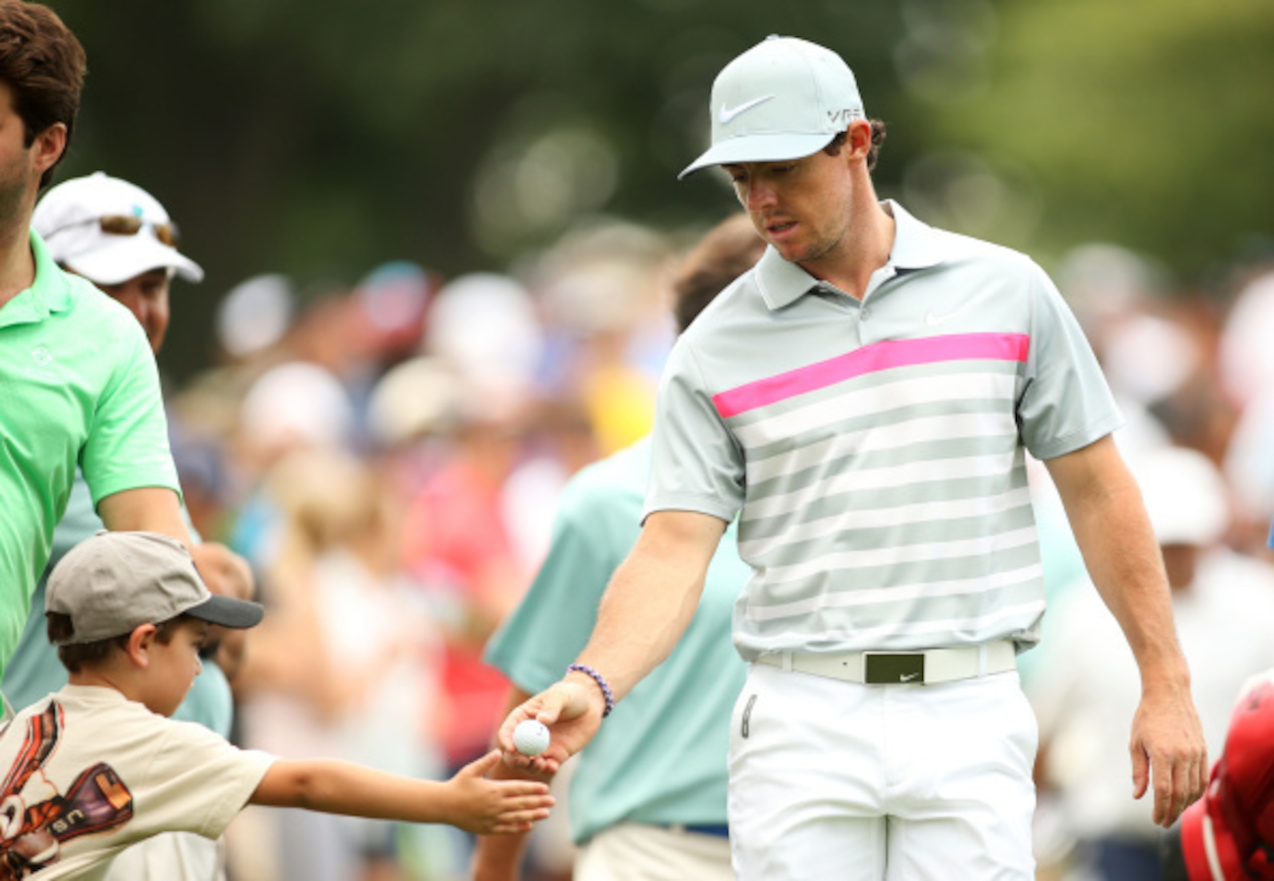 Rory McIlroy makes a young fan happy with a golf ball.