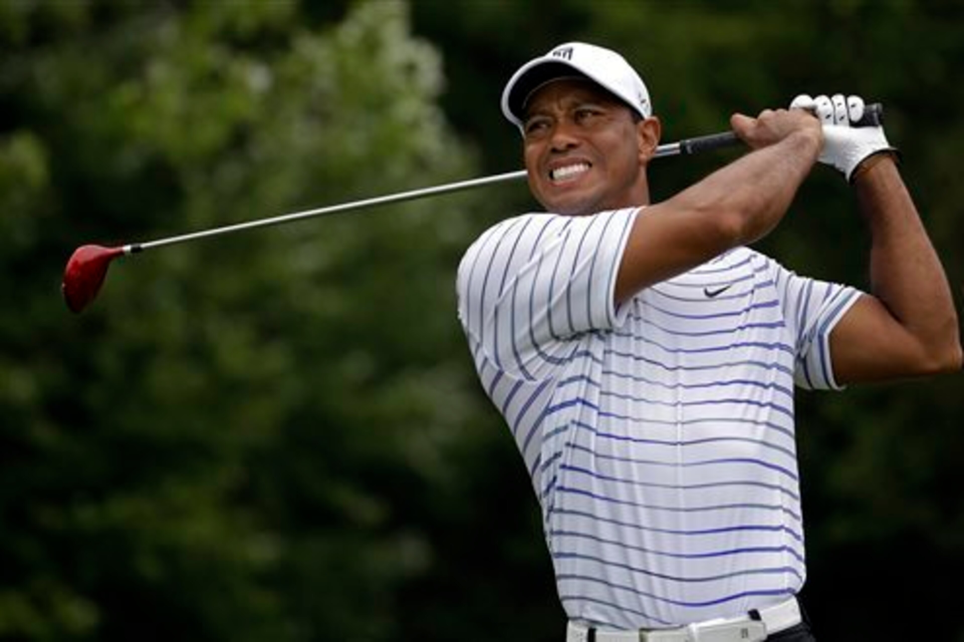 That's not a smile, but a grimace on the face of injured Tiger Woods this year.