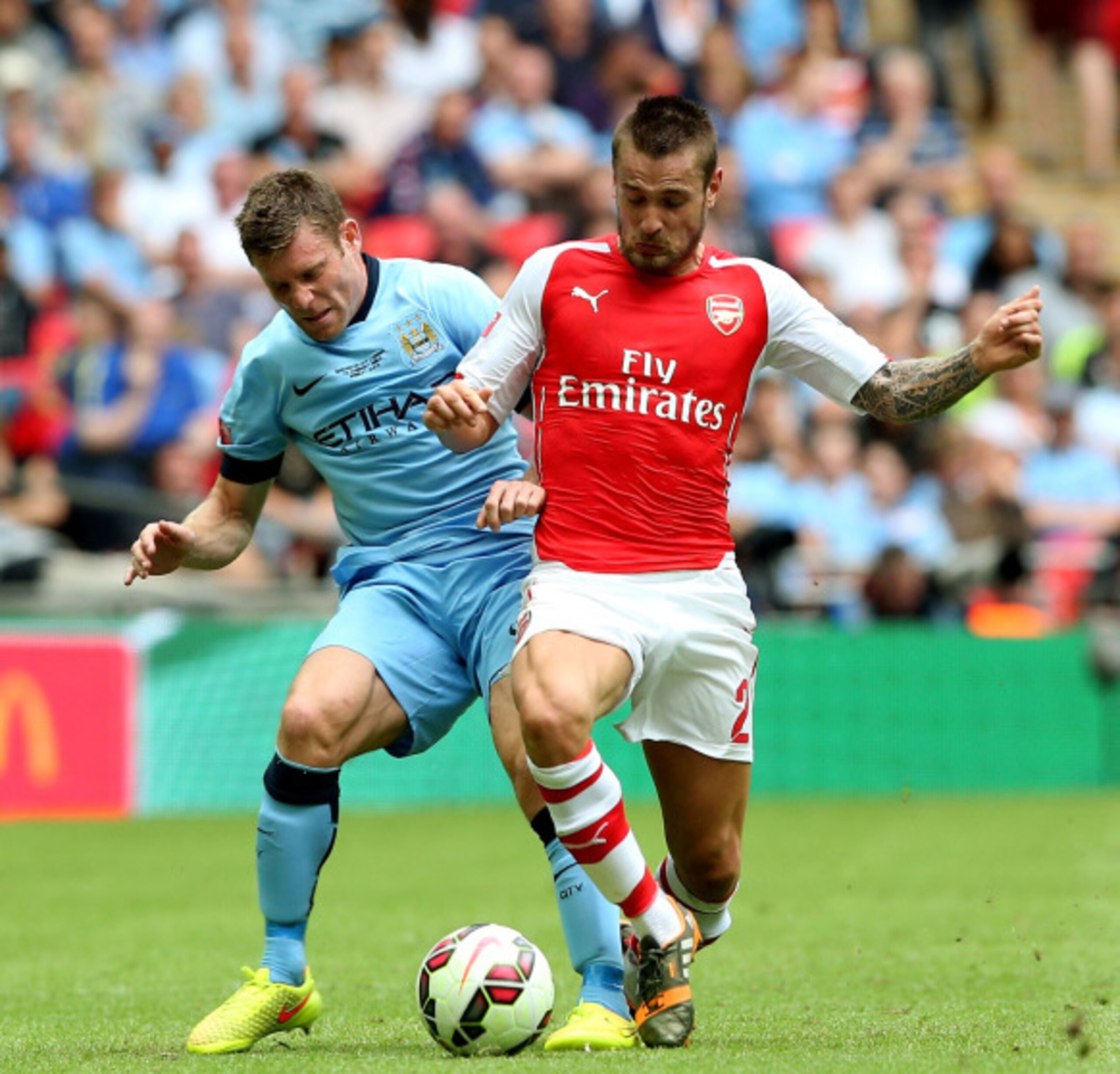 LONDON, ENGLAND - AUGUST 10:James Milner of Manchester City competes for the ball with Mathieu Debuchy of Arsenal during the FA Community Shield match between Manchester City and Arsenal at Wembley Stadium on August 10, 2014 in London, England.  (Photo by