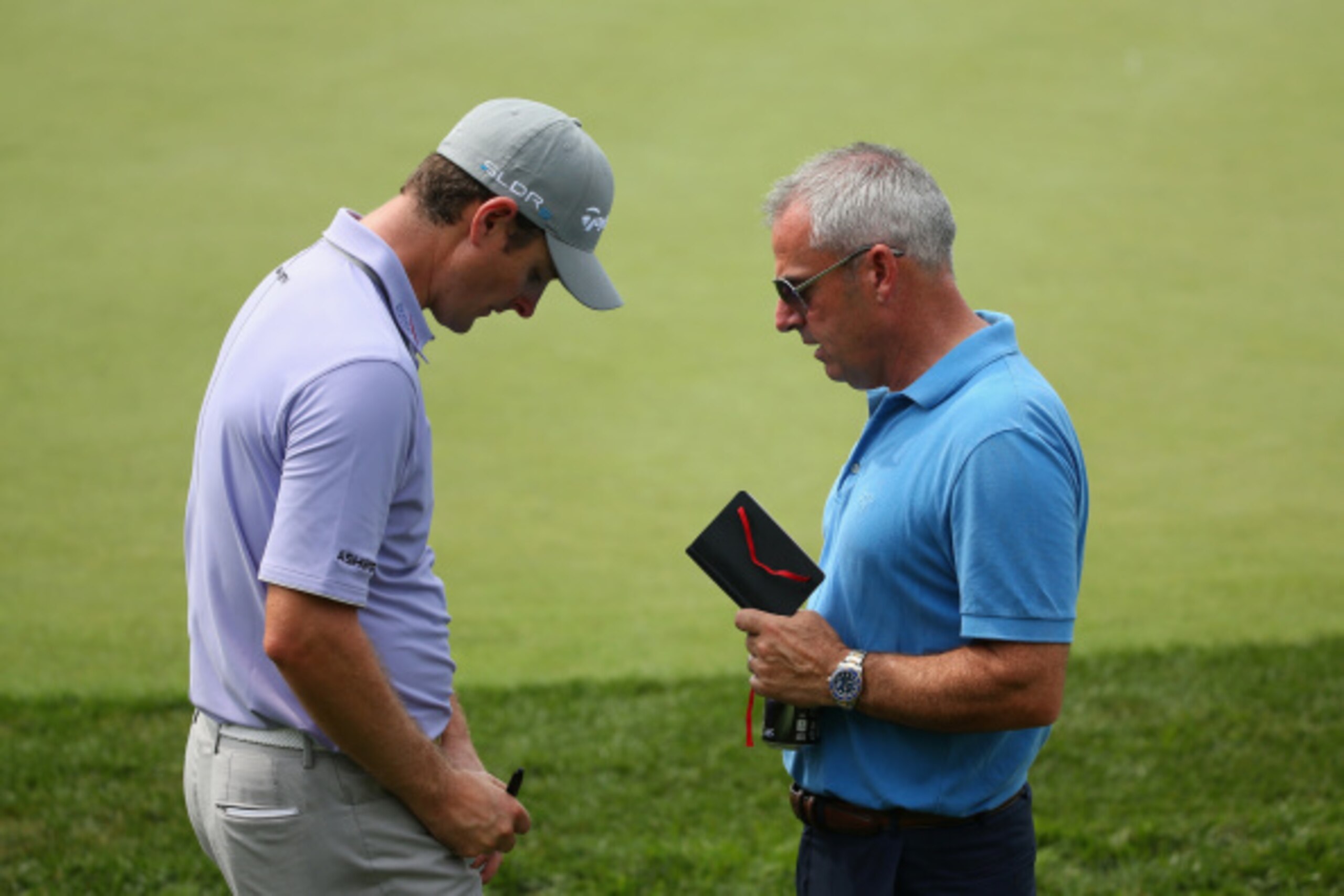 European Ryder Cup captain Paul McGinley talks with one of his key players, Justin Rose.