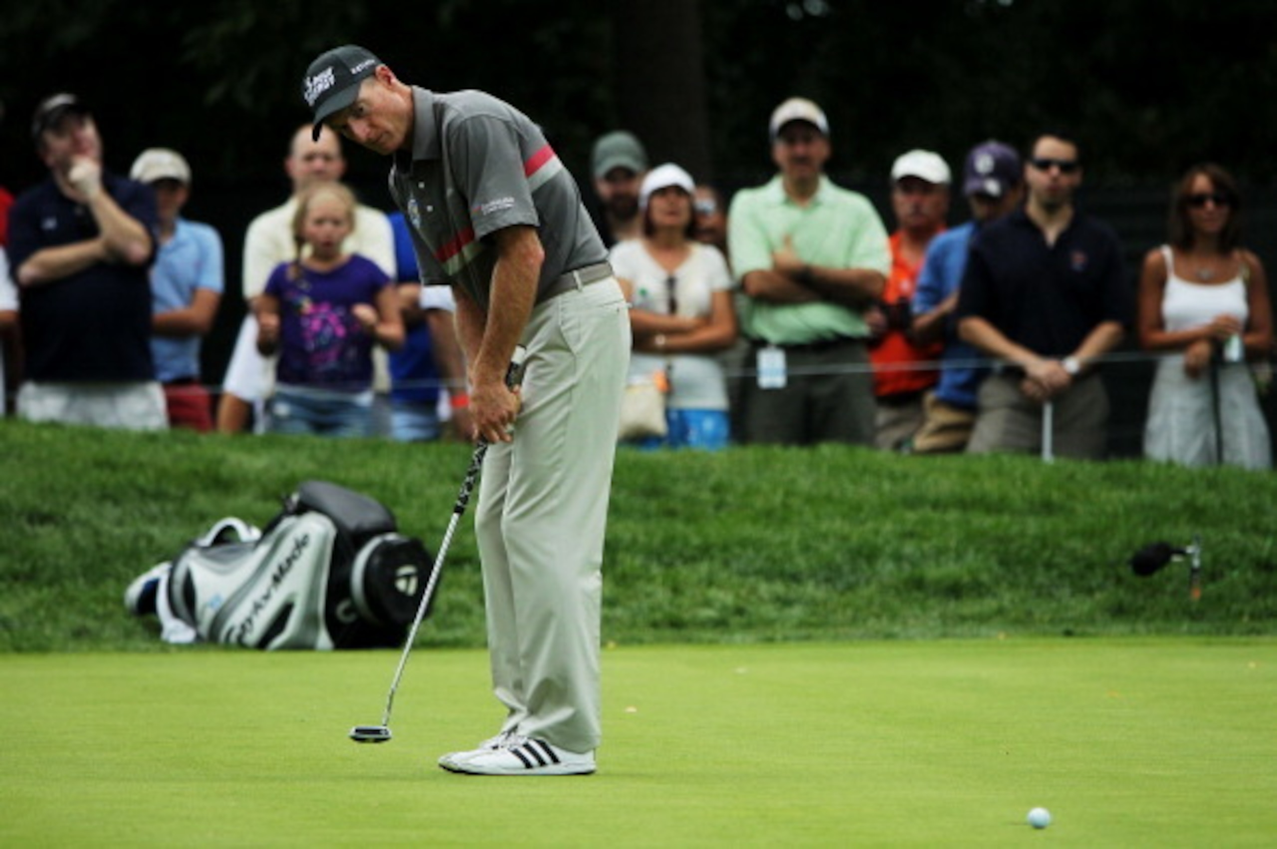 Jim Furyk watches a putt head to the hole.