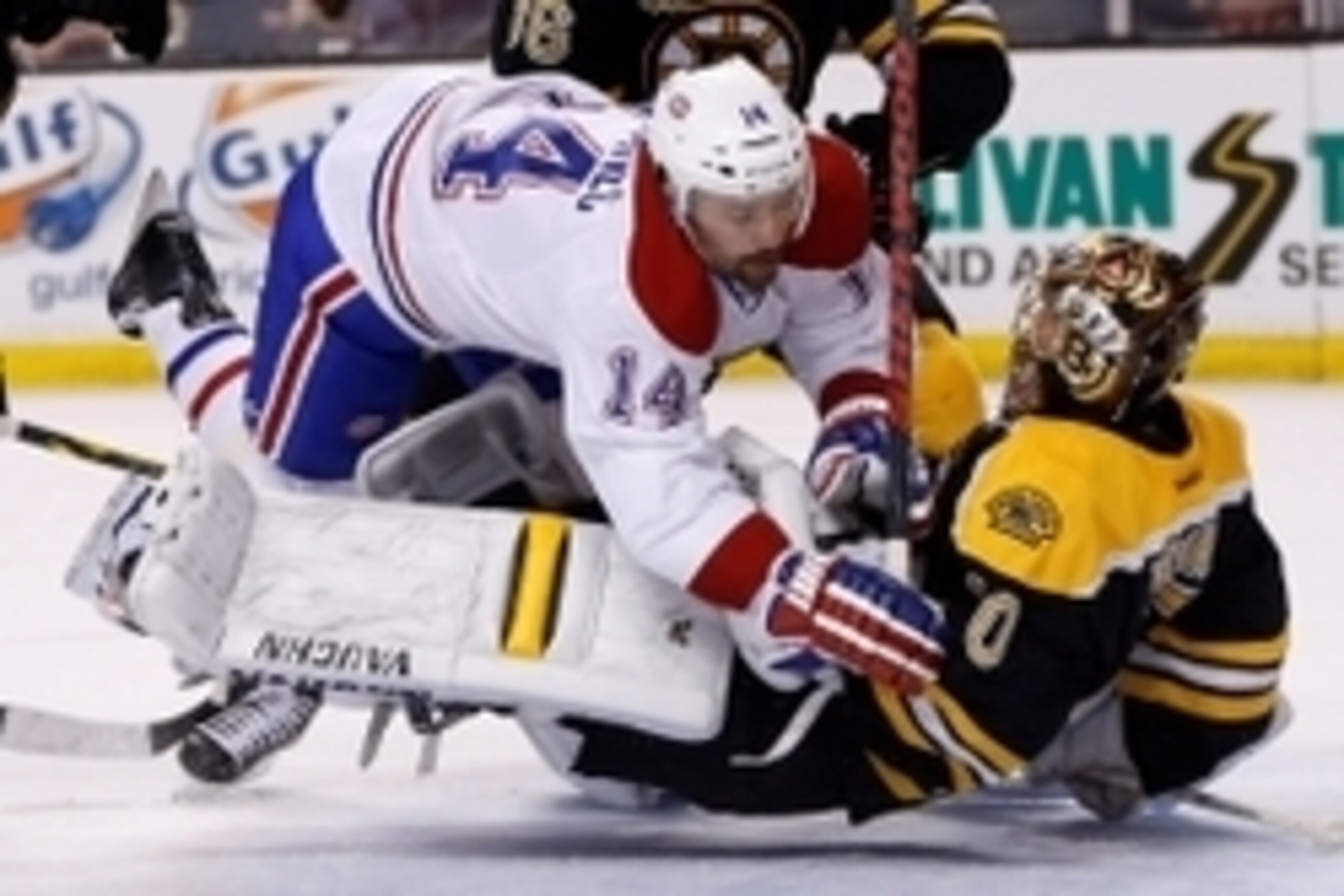 Tomas Plekanec runs over Tuukka Rask.