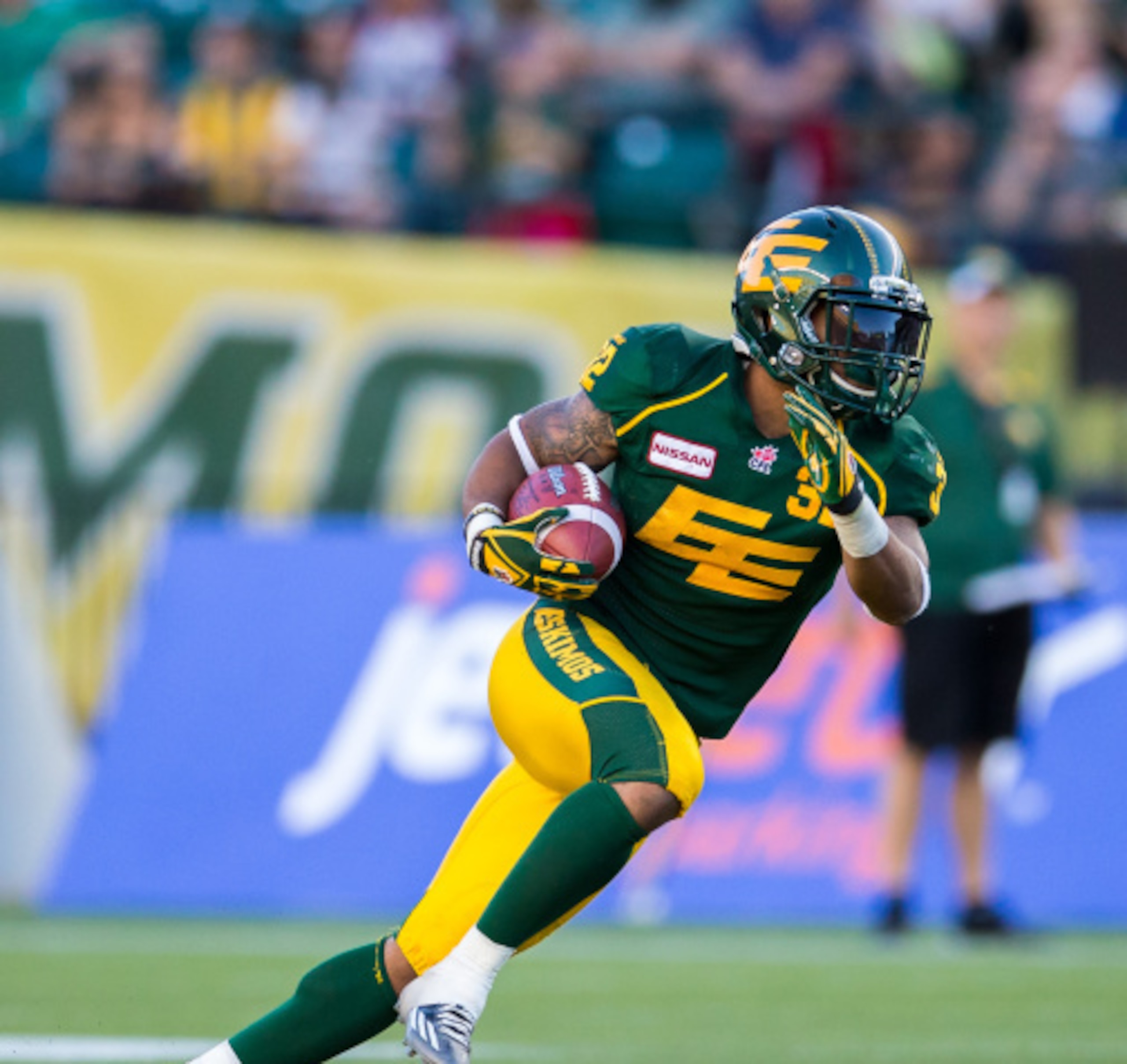 EDMONTON, AB - SEPTEMBER 6: Kendial Lawrence #32 of the Edmonton Eskimos returns a kick in a game between the Calgary Stampeders and Edmonton Eskimos in week 11 of the 2014 CFL season at Commonwealth Stadium on September 6, 2014 in Edmonton, Alberta, Cana