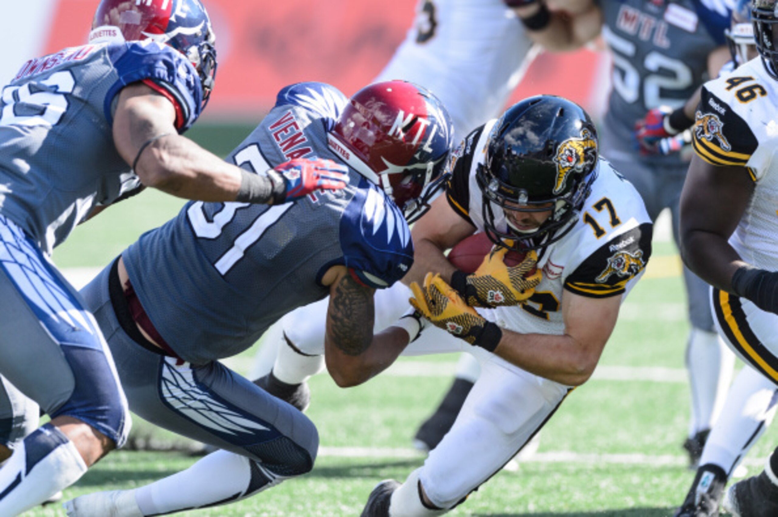 MONTREAL, QC - SEPTEMBER 07: Winston Venable #31 of the Montreal Alouettes tackles Luke Tasker #17 of the Hamilton Tiger-Cats during the CFL game at Percival Molson Stadium on September 7, 2014 in Montreal, Quebec, Canada.  The Alouettes defeat the Tiger-