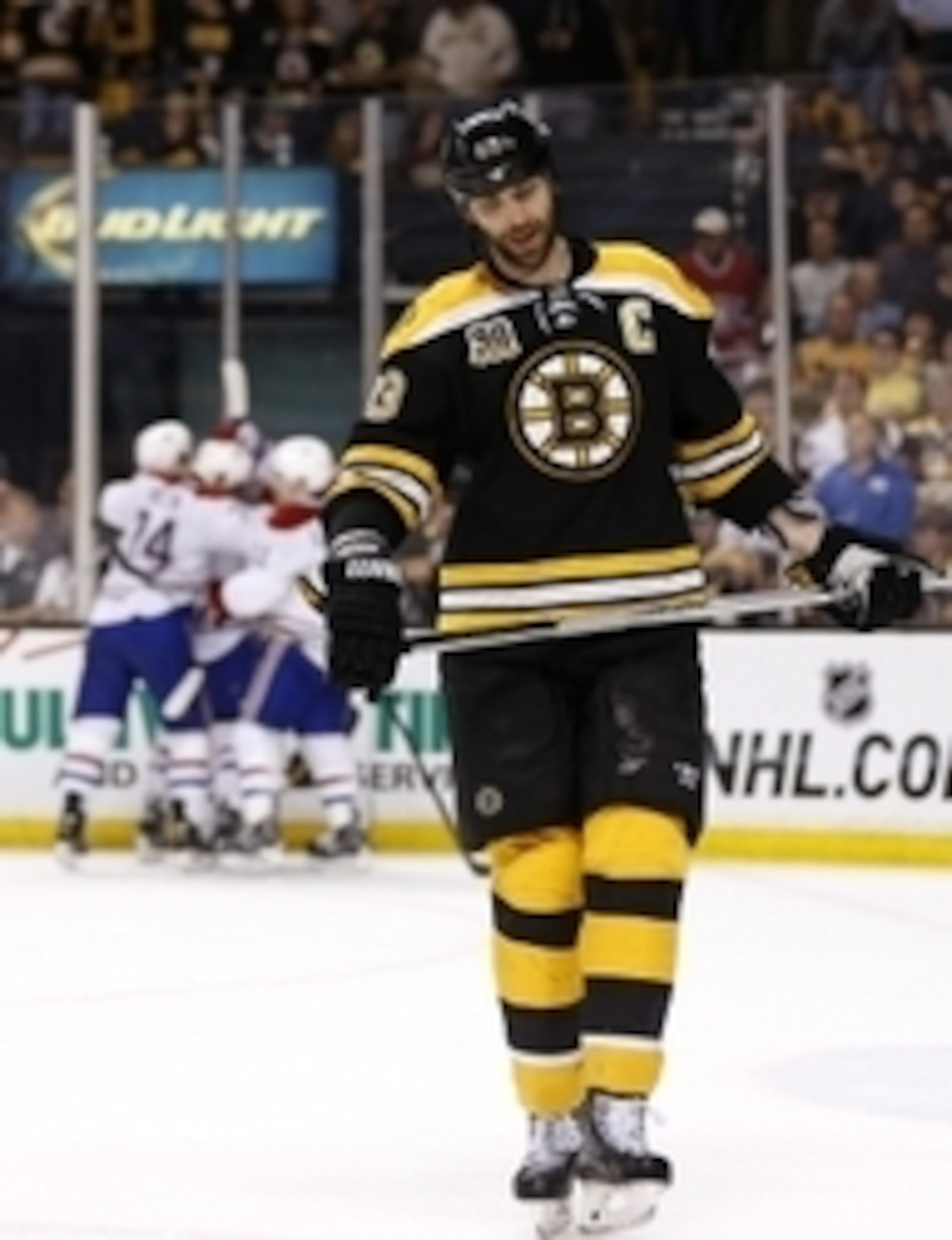 Zdeno Chara skates away as the Montreal Canadiens celebrate in the background.