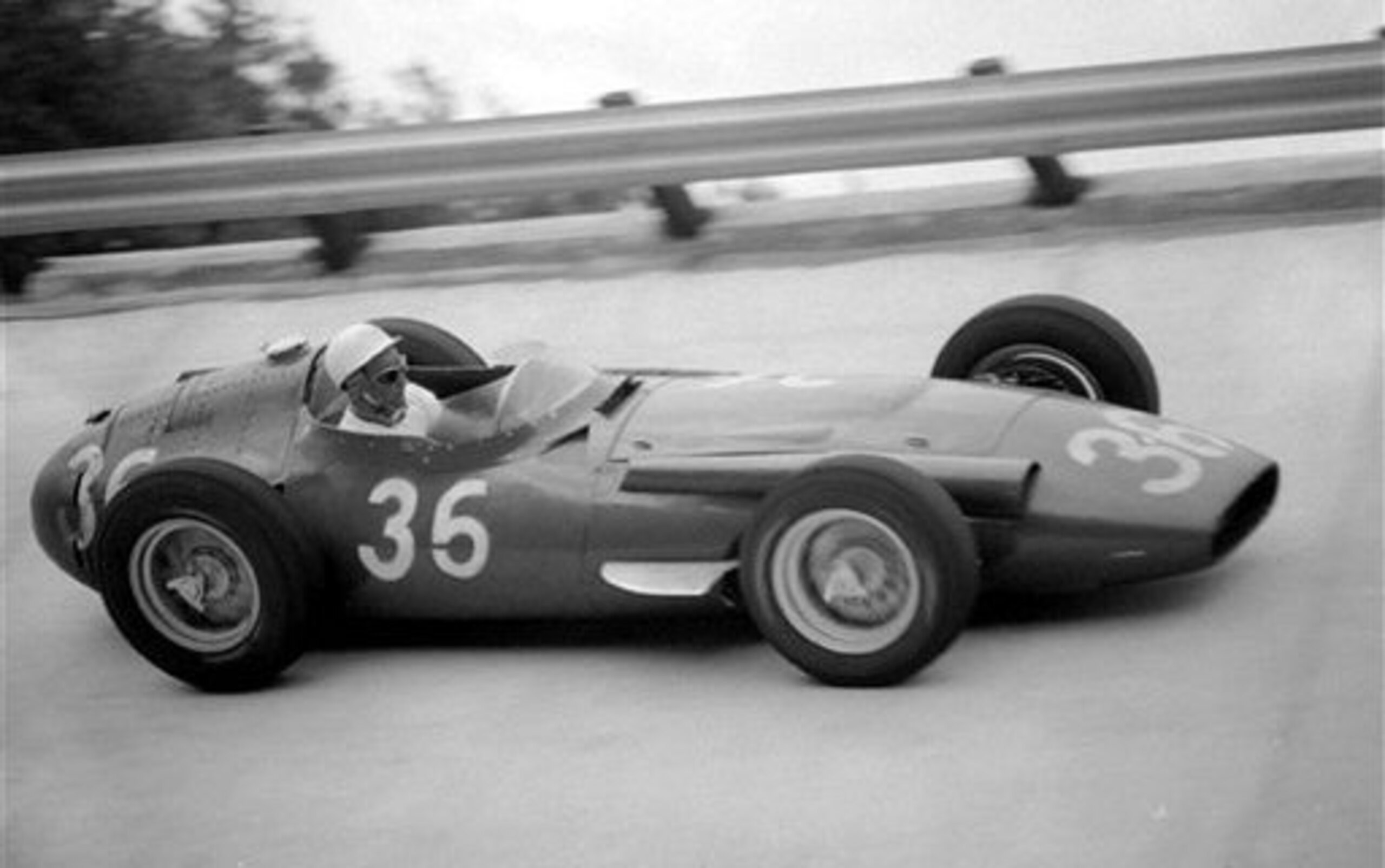 Stirling Moss on the banking in 1956.