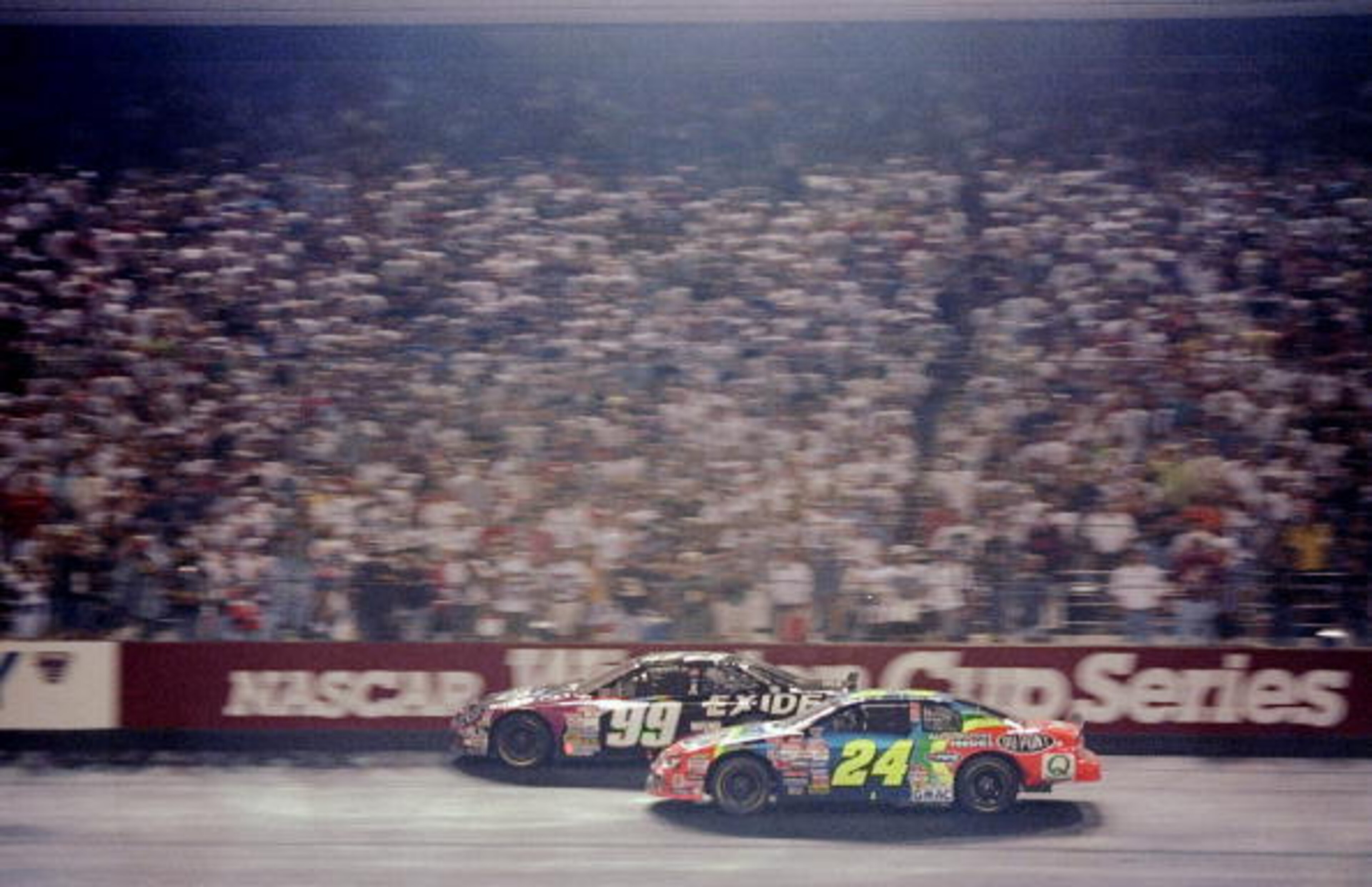 Action from 1998: Jeff Gordon (24) battles eventual race winner Jeff Burton (99).