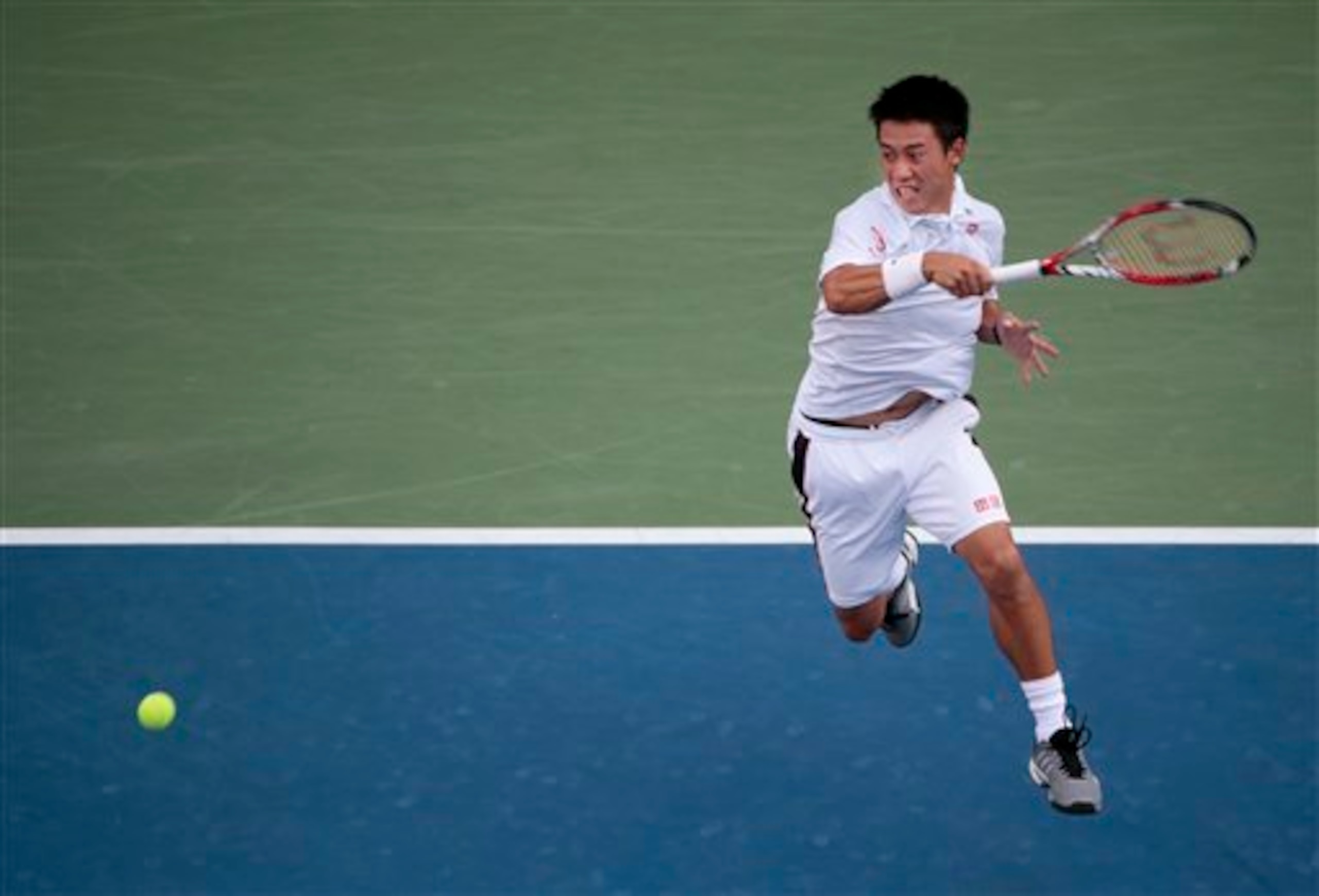 Kei Nishikori rips a forehand during his match against Stan Wawrinka.