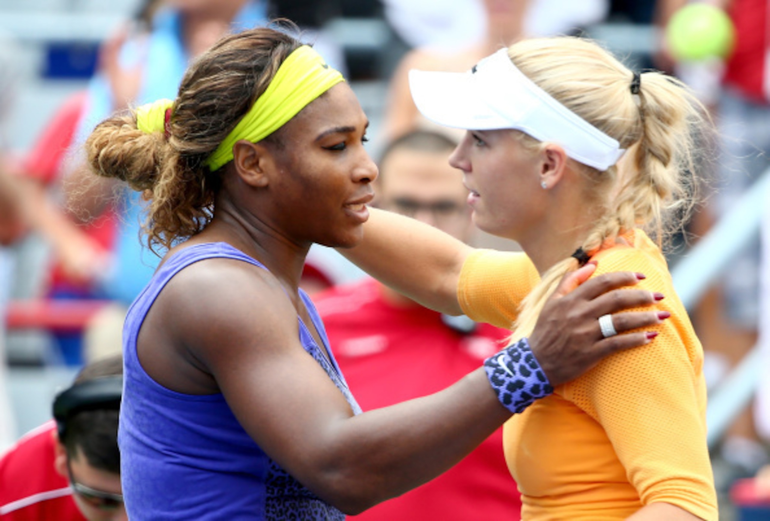 Serena Williams and Caroline Wozniacki embrace after a match at the 2014 Rogers Cup in Montreal.