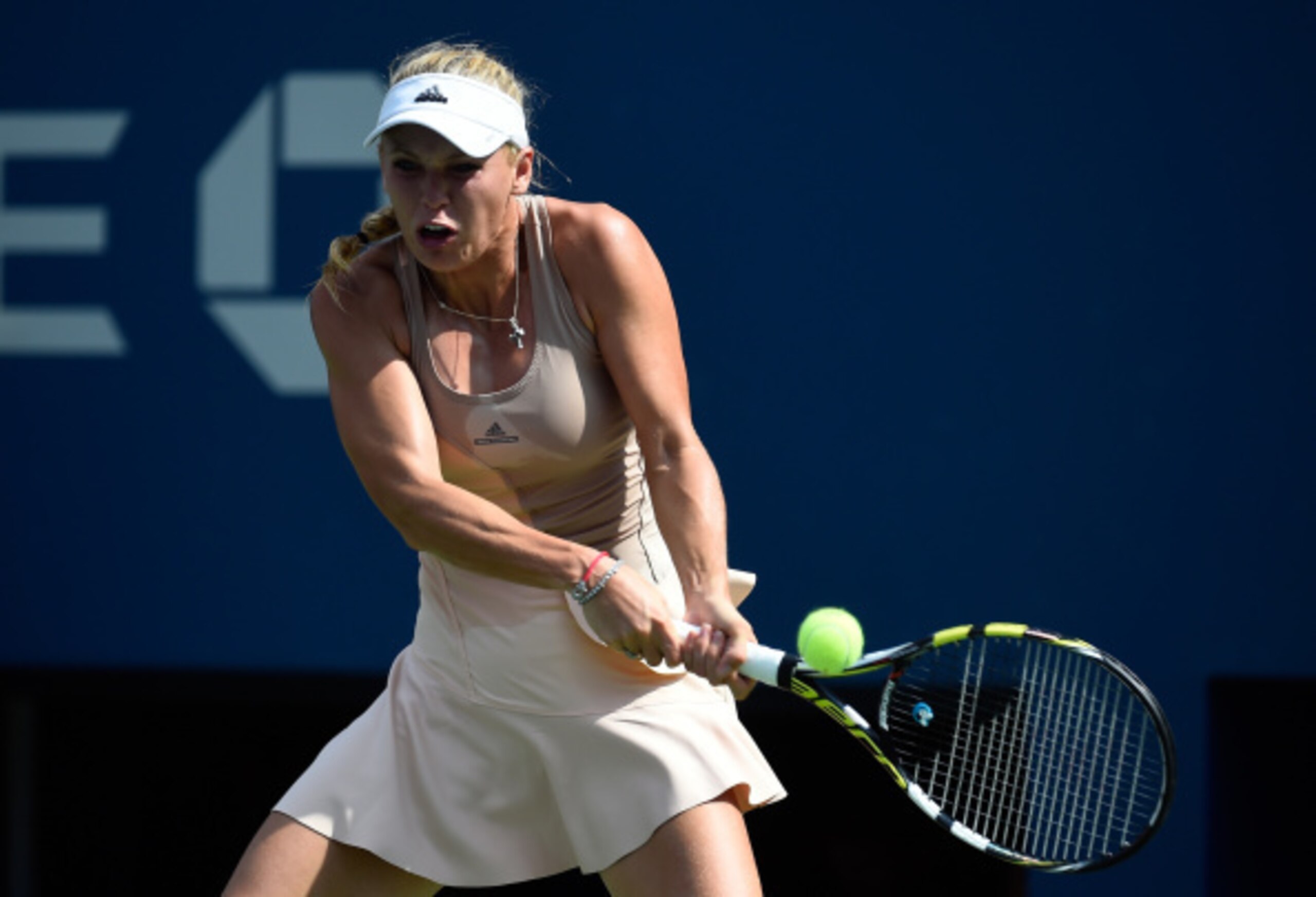 Wozniacki hits a backhand during her match against Peng Shuai in the semifinals of the 2014 U.S. Open.