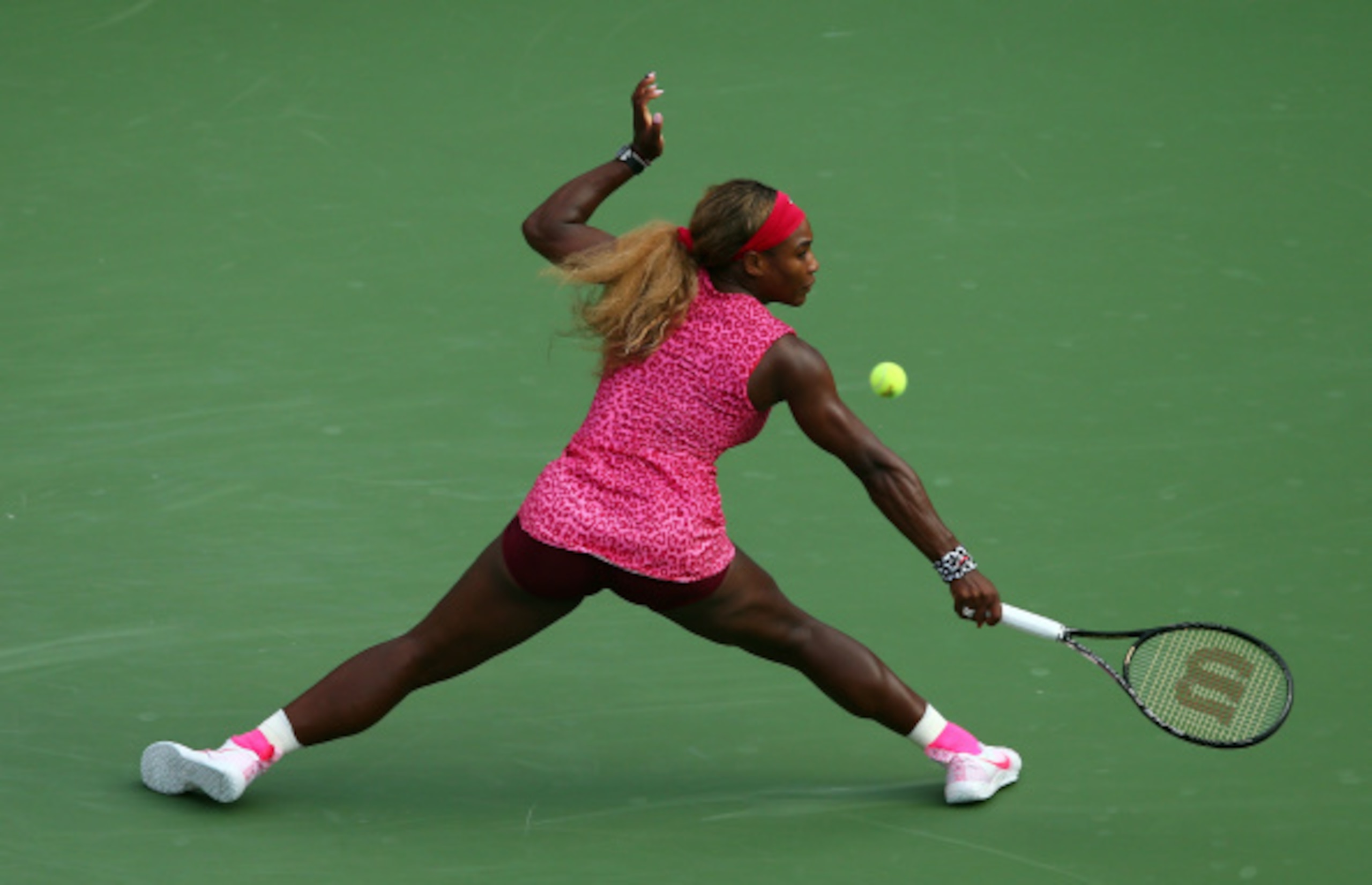 Serena Williams slides to make a play on the ball during her semifinal match at the 2014 U.S. Open.