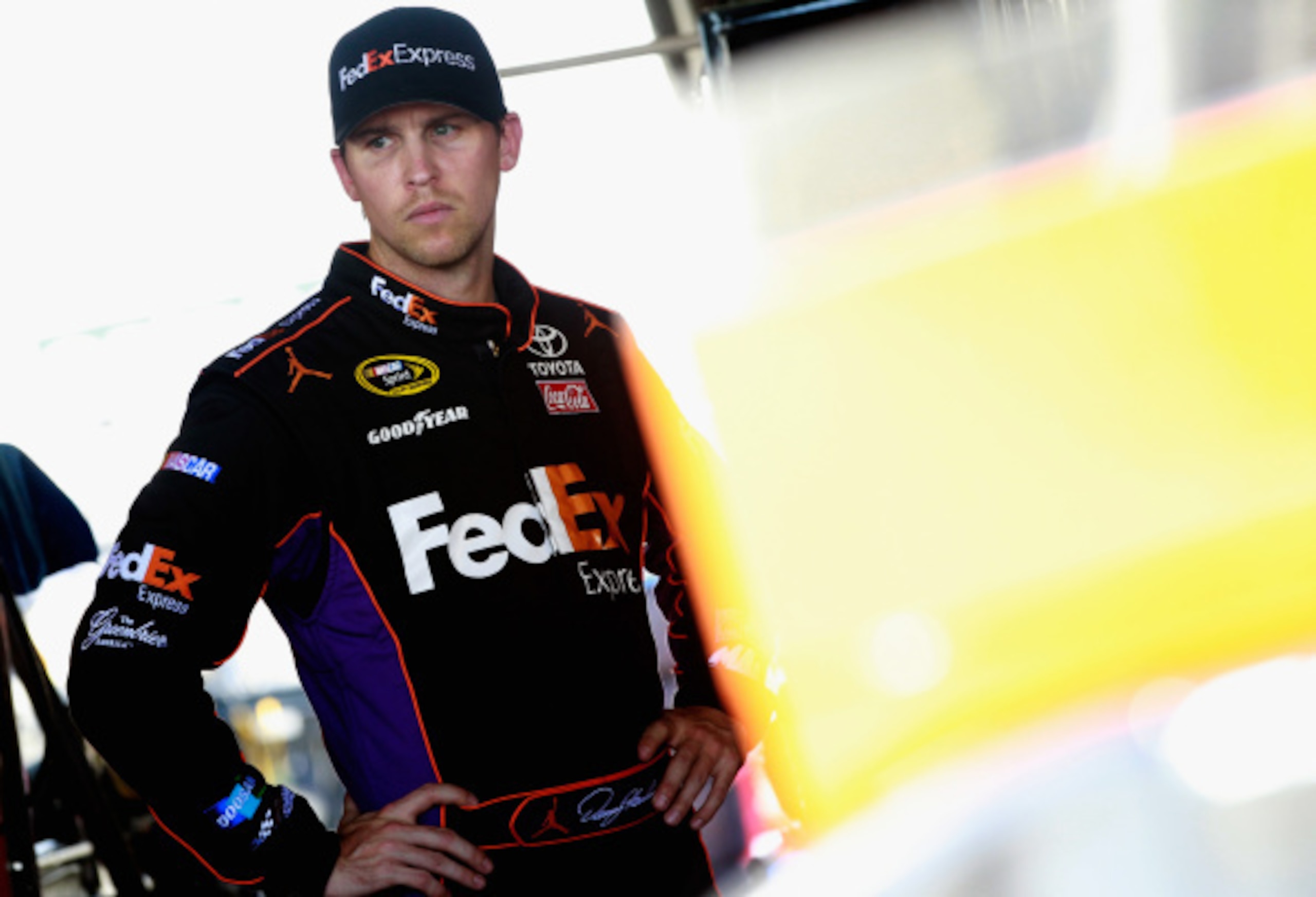 RICHMOND, VA - SEPTEMBER 05:  Denny Hamlin, driver of the #11 FedEx Express Toyota, looks on in the garage area during practice for the NASCAR Sprint Cup Series Federated Auto Parts 400 at Richmond International Raceway on September 5, 2014 in Richmond, V
