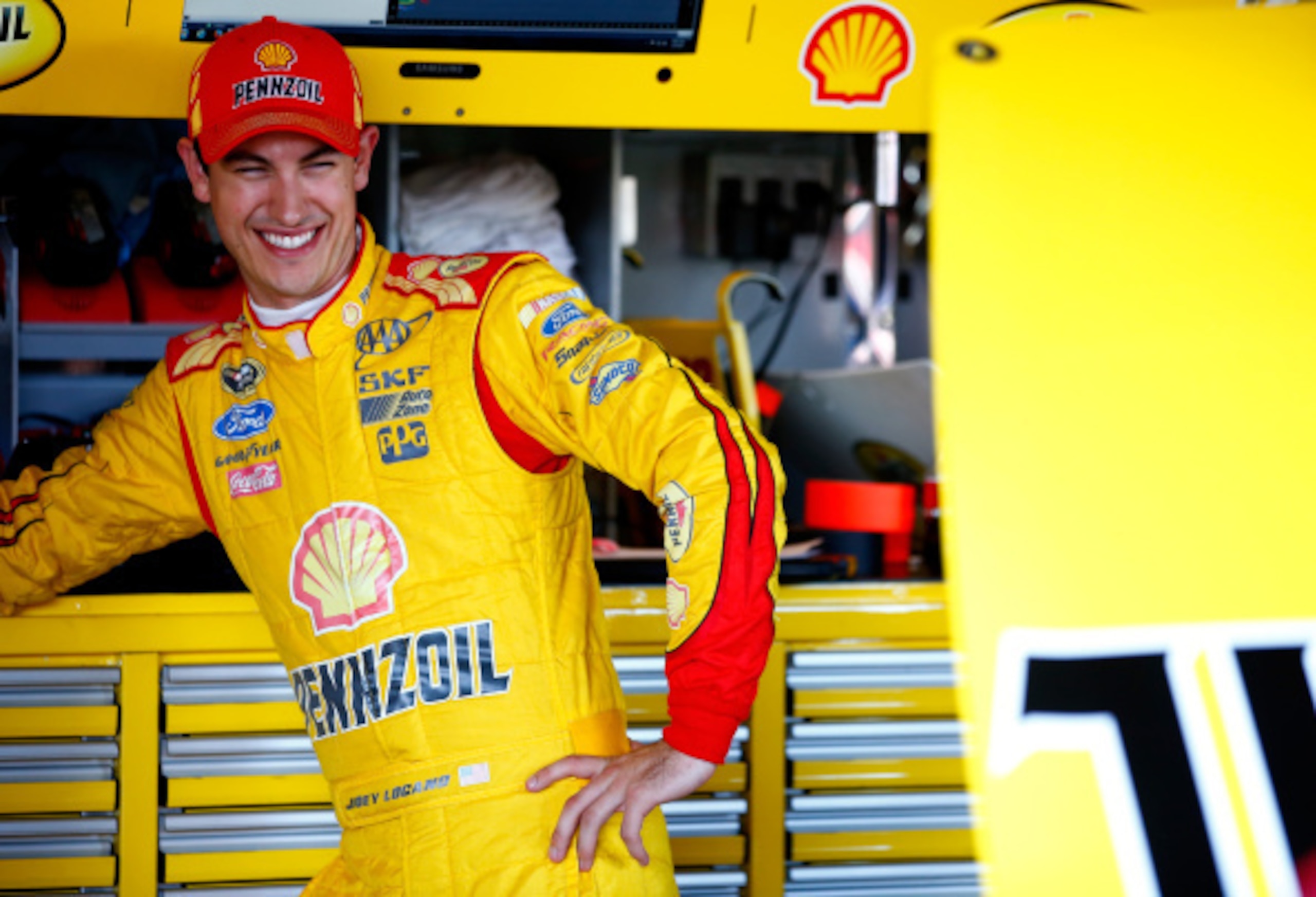 RICHMOND, VA - SEPTEMBER 05:  Joey Logano, driver of the #22 Shell-Pennzoil Ford, stands in the garage area during practice for the NASCAR Sprint Cup Series Federated Auto Parts 400 at Richmond International Raceway on September 5, 2014 in Richmond, Virgi