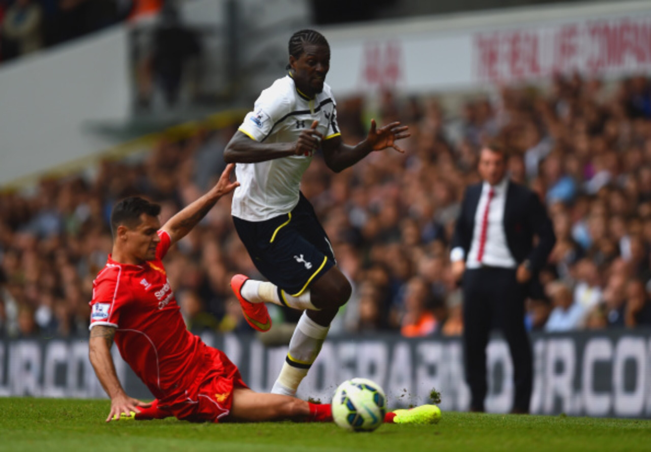 LONDON, ENGLAND - AUGUST 31: Emmanuel Adebayour of Spurs is tackled by Dejan Lovren of Liverpool during the Barclays Premier League match between Tottenham Hotspur and Liverpool at White Hart Lane on August 31, 2014 in London, England. (Photo by Jamie M LONDON, ENGLAND - AUGUST 31: Emmanuel Adebayour of Spurs is tackled by Dejan Lovren of Liverpool during the Barclays Premier League match between Tottenham Hotspur and Liverpool at White Hart Lane on August 31, 2014 in London, England. (Photo by Jamie M