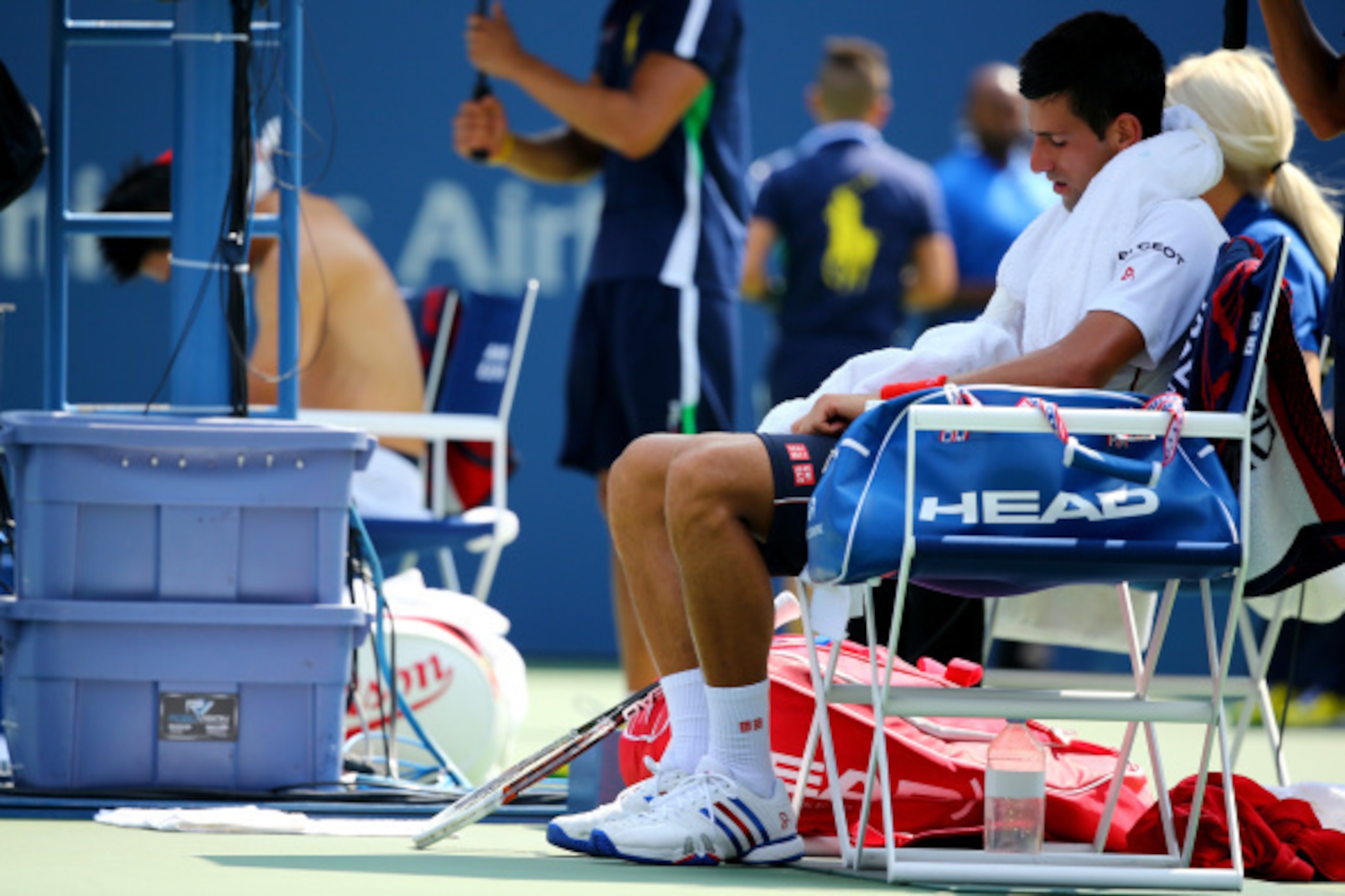 Novak Djokovic tries to cool off during a match against Kei Nishikori at the 2014 U.S. Open.