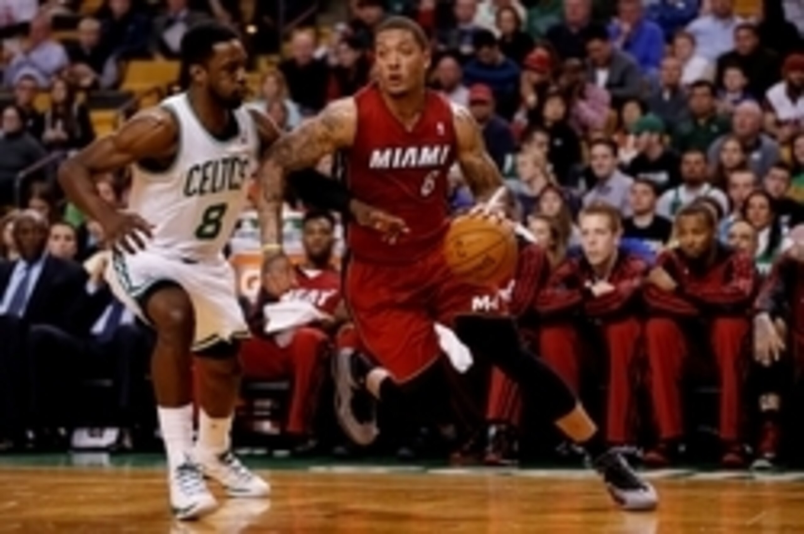 Mar 19, 2014; Boston, MA, USA; Miami Heat forward Michael Beasley (8) dribbles the ball as Boston Celtics guard/forward Jeff Green (8) chases during the first quarter at TD Garden. Mandatory Credit: Greg M. Cooper-USA TODAY Sports