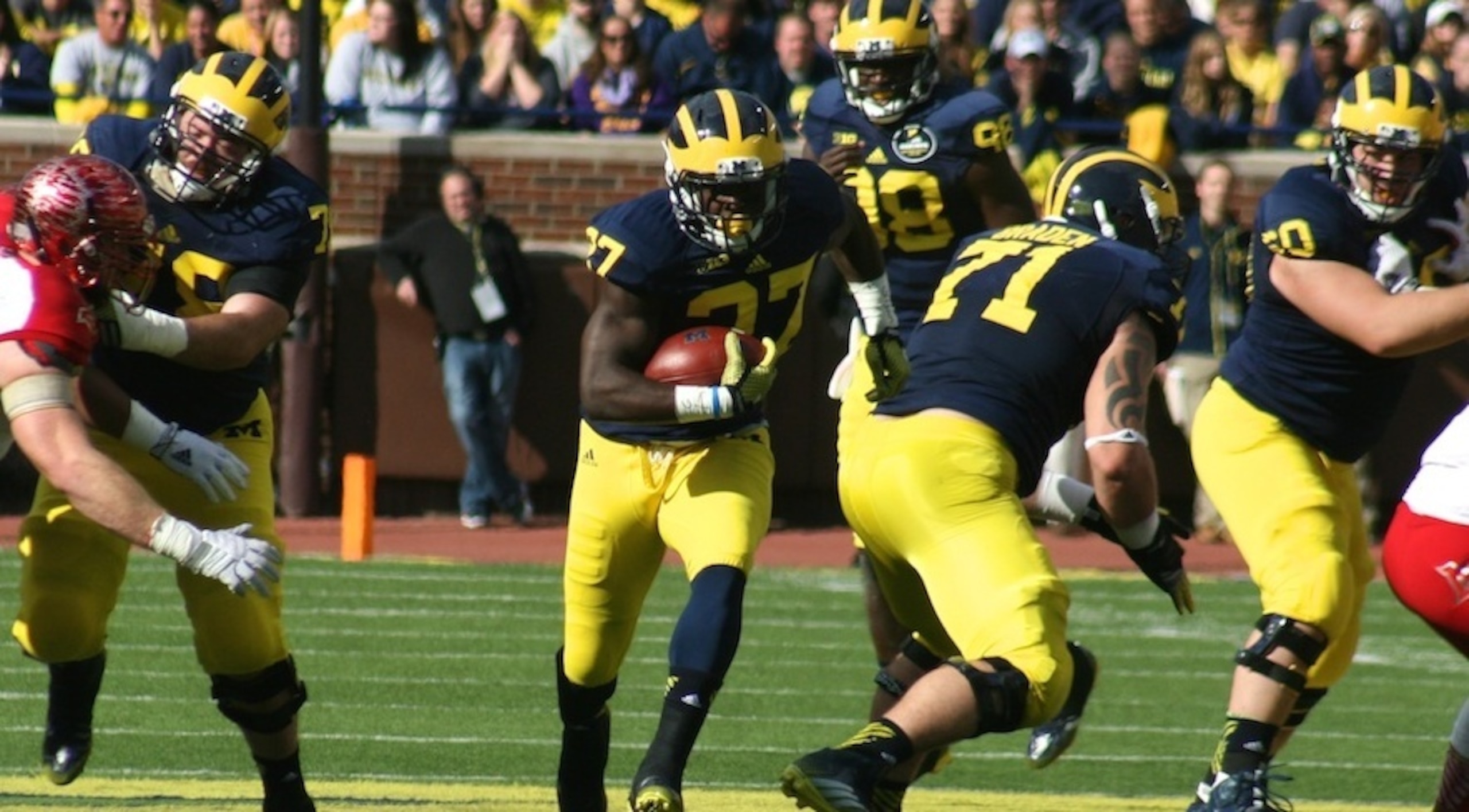 The offensive line opens up a hole for Derrick Green
