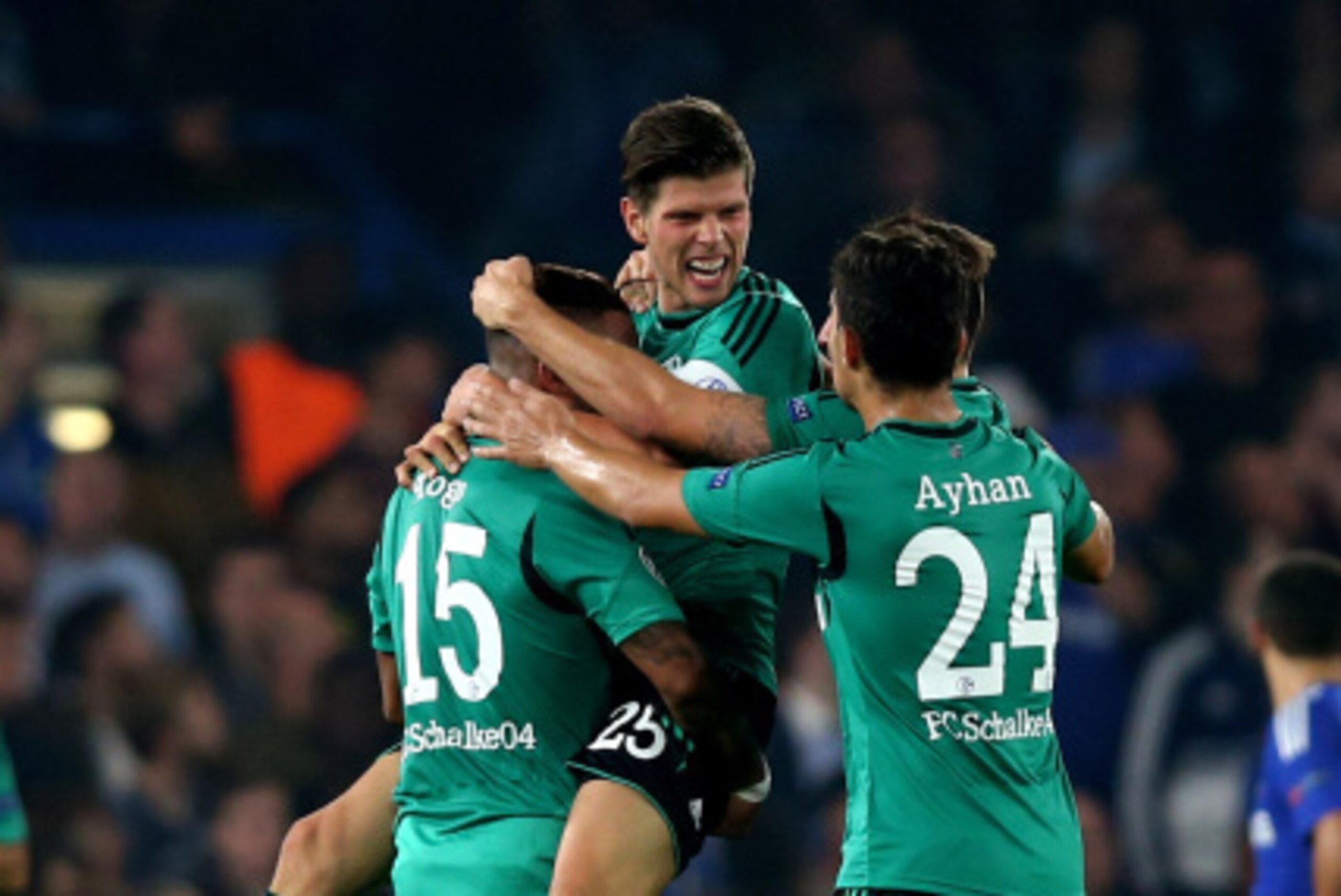 Klaas-Jan Huntelaar is congratulated by his Schalke team-mates after scoring the goal that would earn his side a point against Chelsea.
