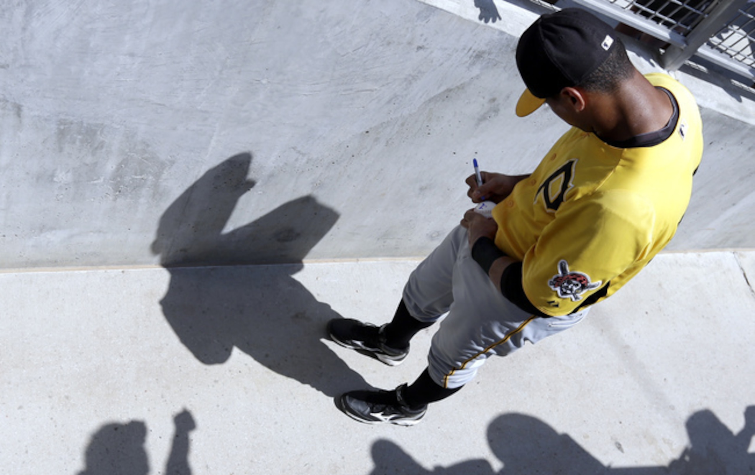 Elias Diaz signs an autograph during Spring Training