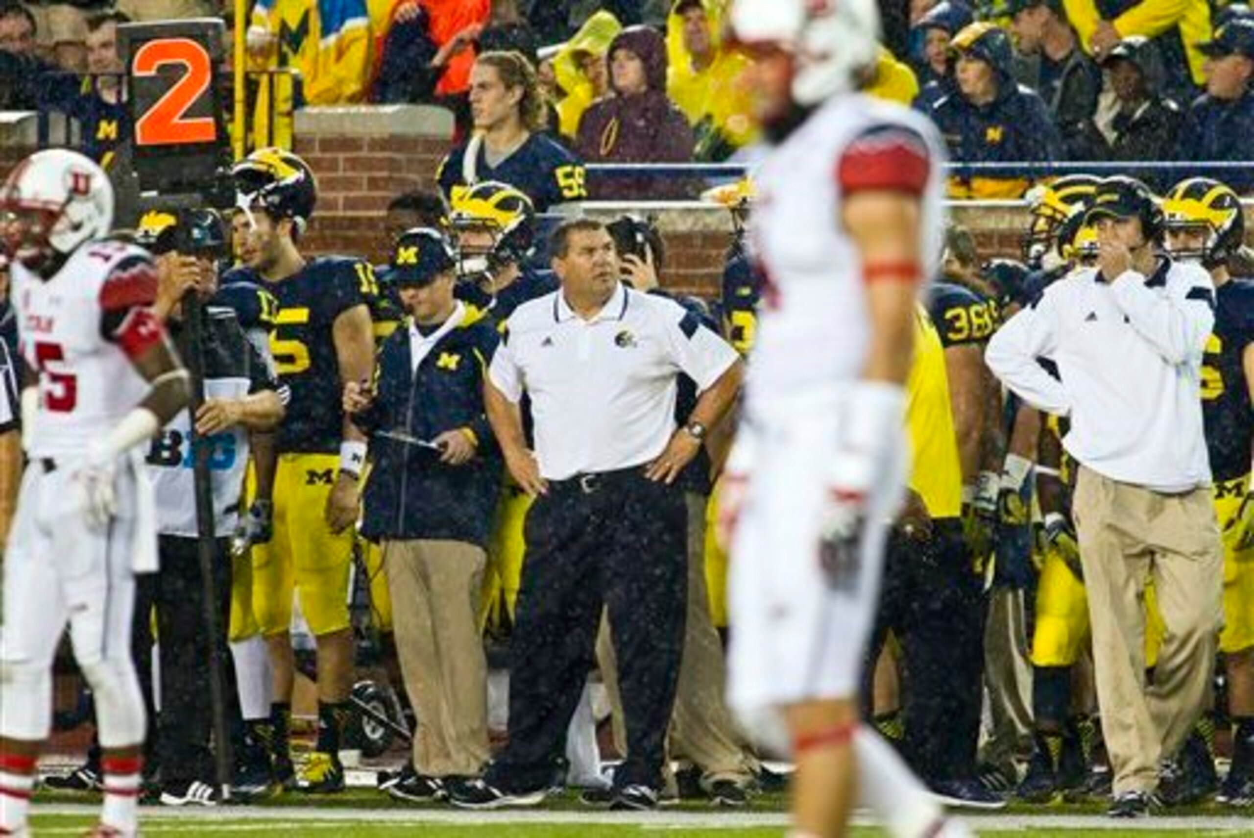 Michigan coach Brady Hoke (center) stares off in wonder of what has happened to his team's season already.