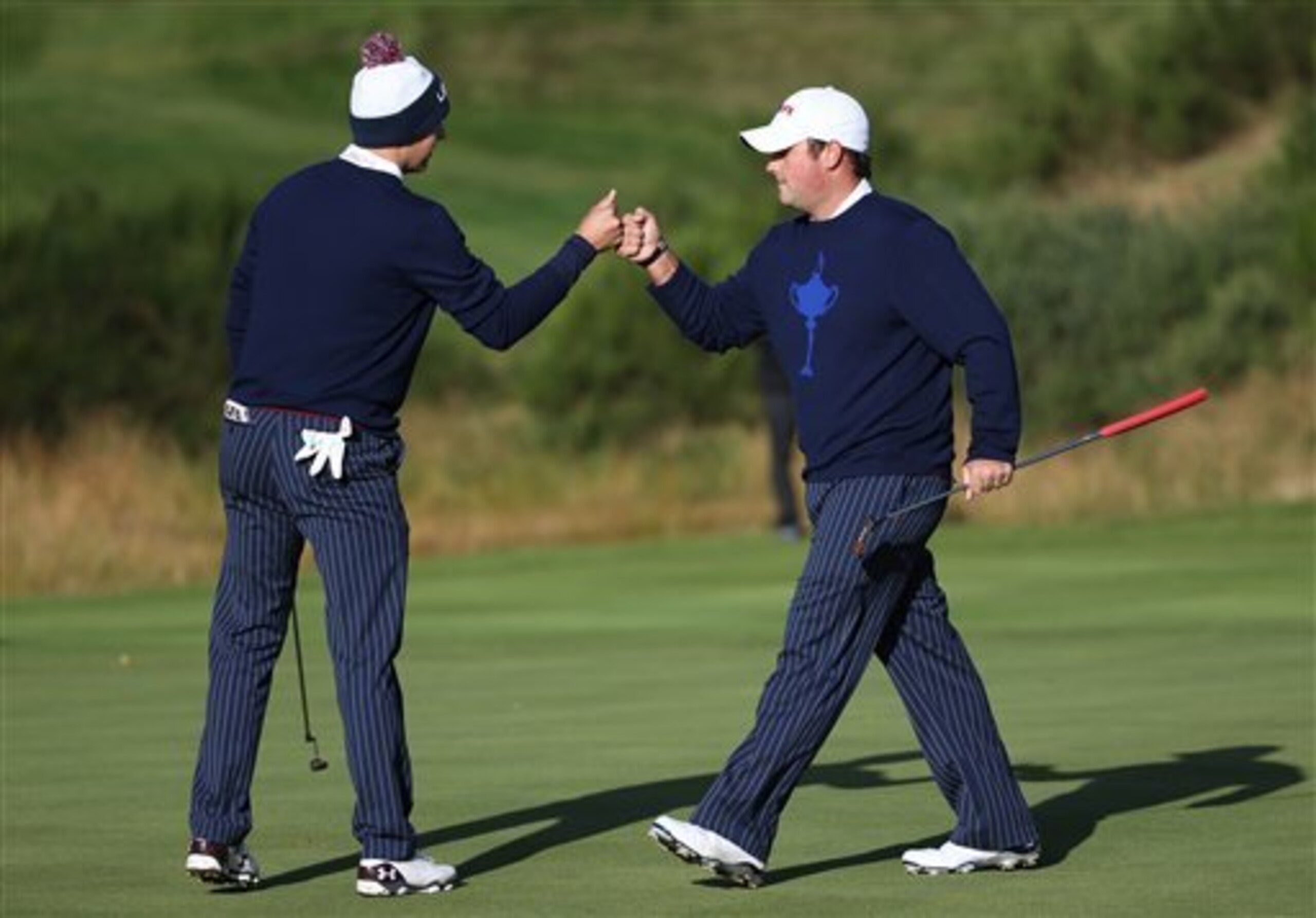 Patrick Reed (right) gets congratulations from partner Jordan Spieth.