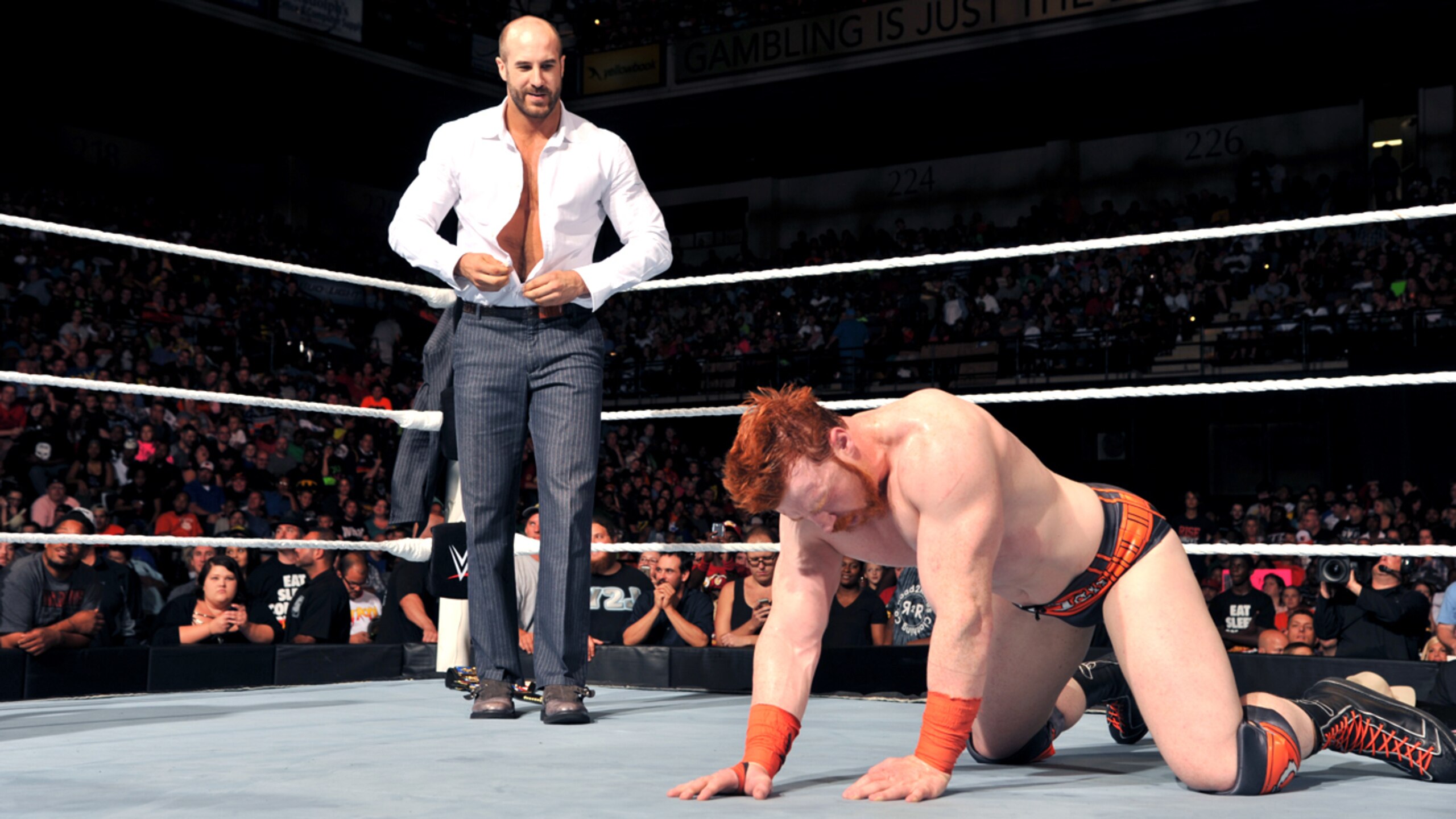 Cesaro stands over a fallen Sheamus.