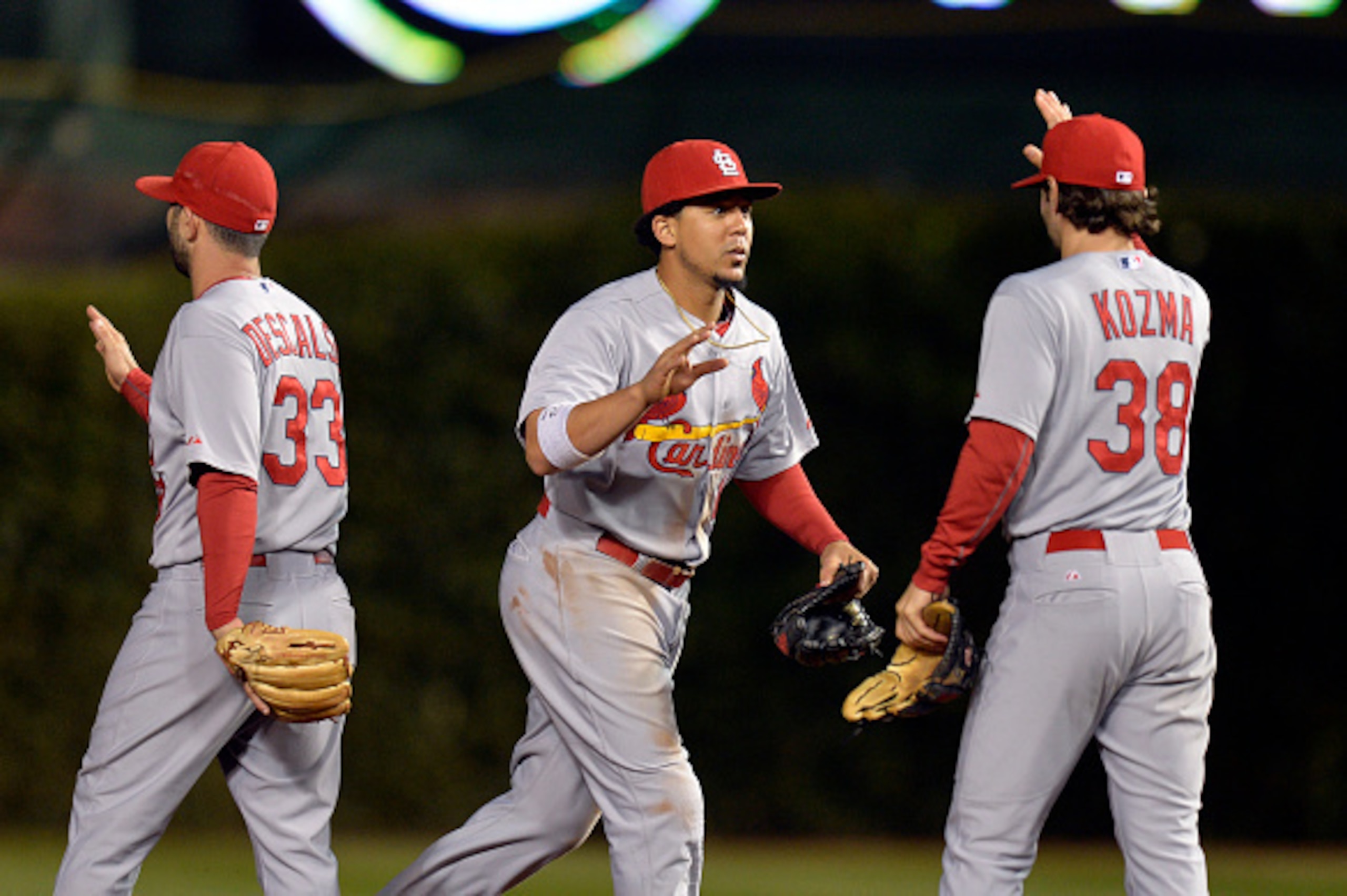 Daniel Descalso, Jon Jay and Pete Kozma congratulate each other after defeating the Cubs on Sept. 22.