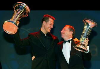 Michael raises the drivers' championship trophy.