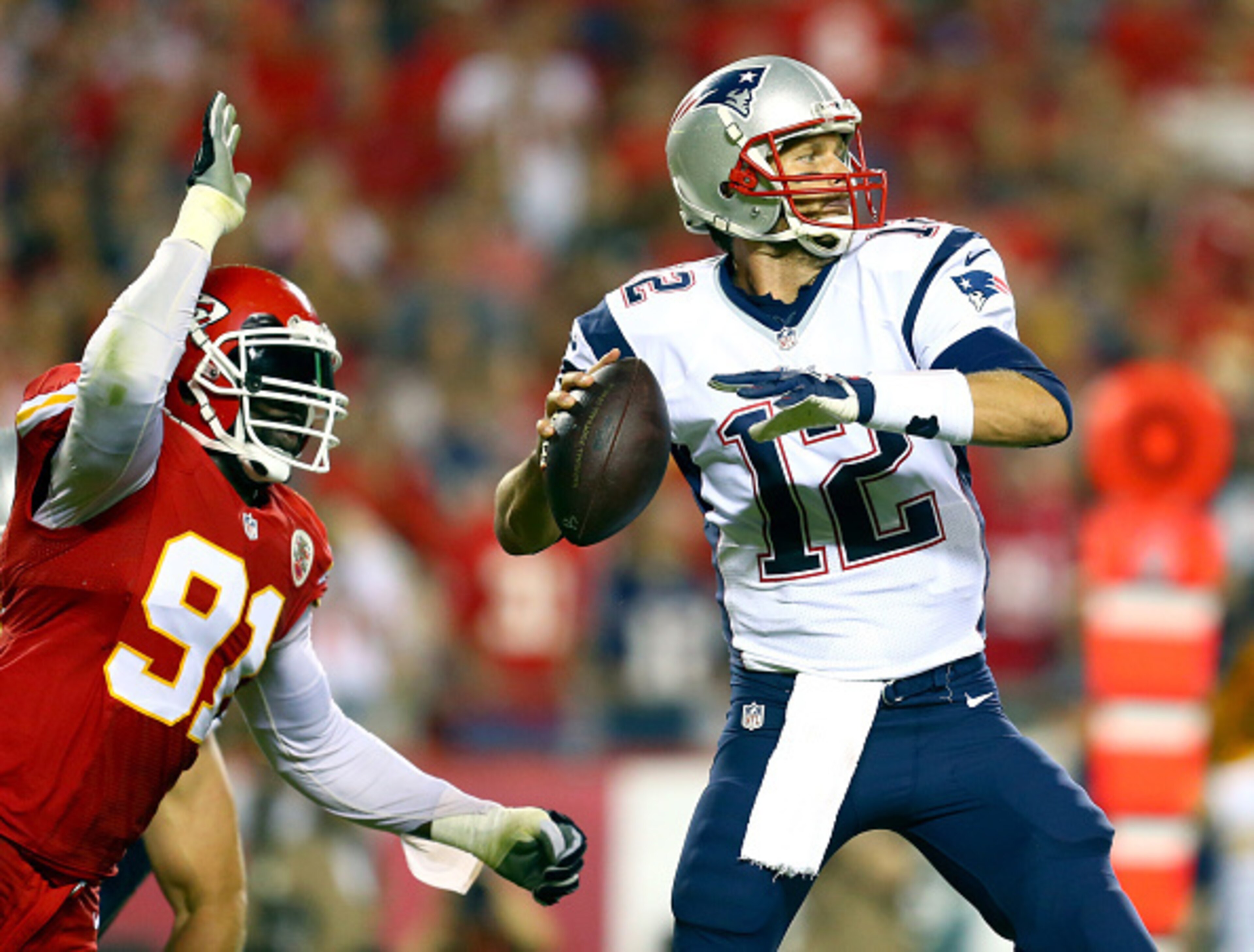 KANSAS CITY, MO - SEPTEMBER 29: Tamba Hali #91 of the Kansas City Chiefs knocks the ball loose from Tom Brady #12 of the New England Patriots for a fumble during the third quarter at Arrowhead Stadium on September 29, 2014 in Kansas City, Missouri. (Pho KANSAS CITY, MO - SEPTEMBER 29: Tamba Hali #91 of the Kansas City Chiefs knocks the ball loose from Tom Brady #12 of the New England Patriots for a fumble during the third quarter at Arrowhead Stadium on September 29, 2014 in Kansas City, Missouri. (Pho