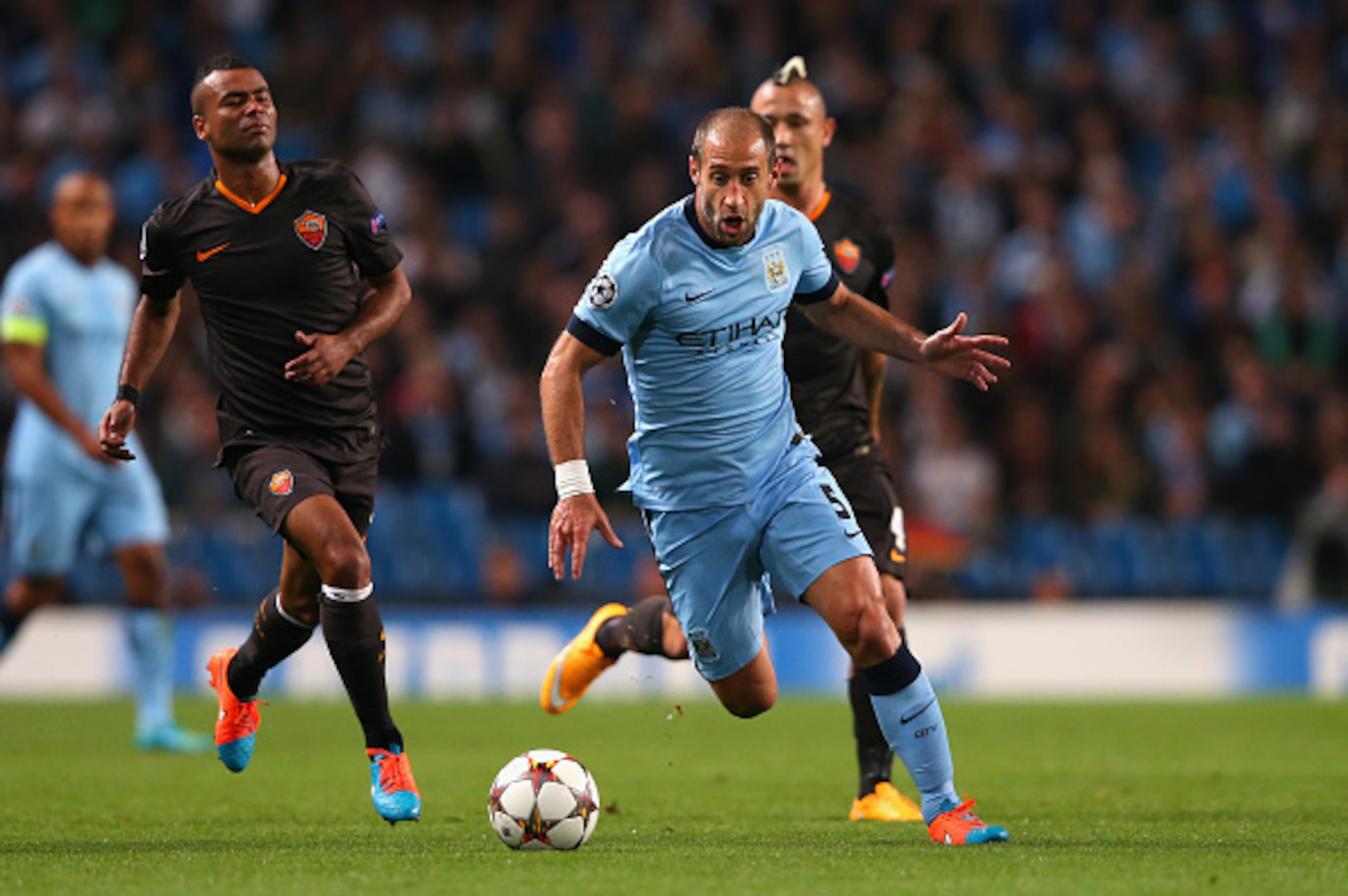 MANCHESTER, ENGLAND - SEPTEMBER 30:  Pablo Zabaleta of Manchester City competes with Ashley Cole of AS Roma during the UEFA Champions League Group E match between Manchester City FC and AS Roma  on September 30, 2014 in Manchester, United Kingdom.  (Photo