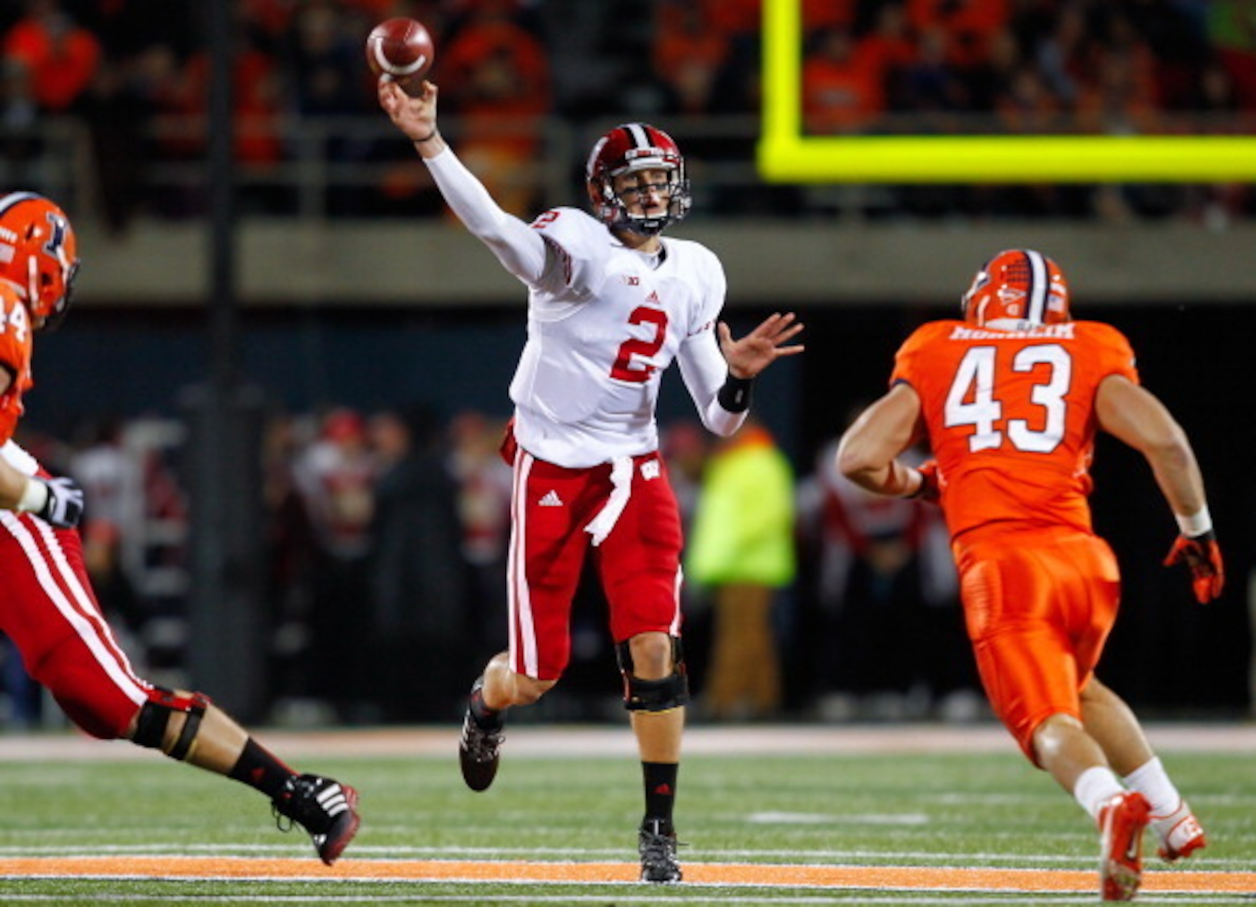 CHAMPAIGN, IL - OCTOBER 19: Joel Stave #2 of the Wisconsin Badgers passes the ball as Mason Monheim #43 of the Illinois Fighting Illini rushes at Memorial Stadium on October 19, 2013 in Champaign, Illinois. Wisconsin defeated Illinois 56-32. (Photo by Mic