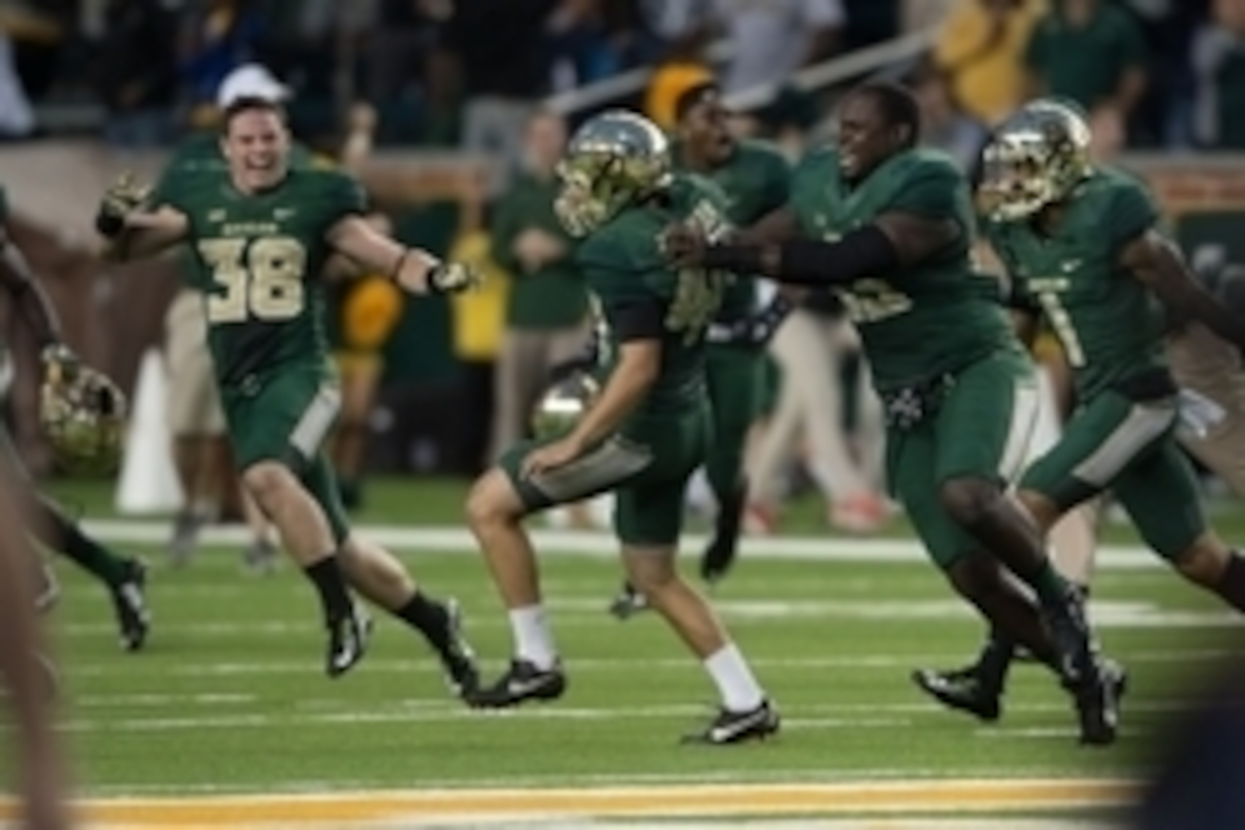 Chris Callahan (center) celebrates with Baylor teammates after kicking the game-winning 28-yard field goal in the Bears' 61-58 win over TCU.