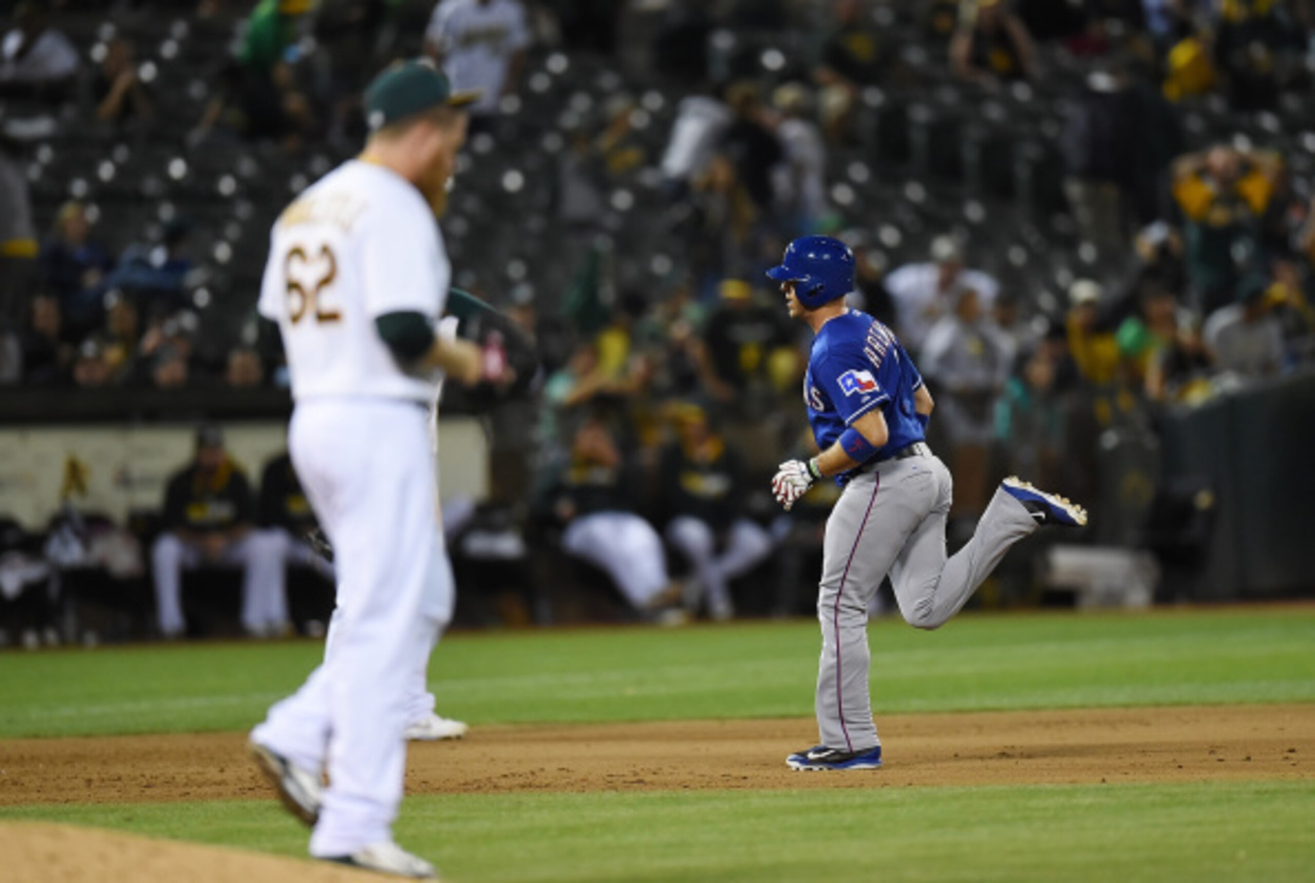 Rangers catcher J.P. Arencibia rounds the bases after hitting a three-run homer off A's closer Sean Doolittle.