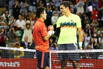 Kei Nishikori shakes hands with Milos Raonic at the 2014 Japan Open.