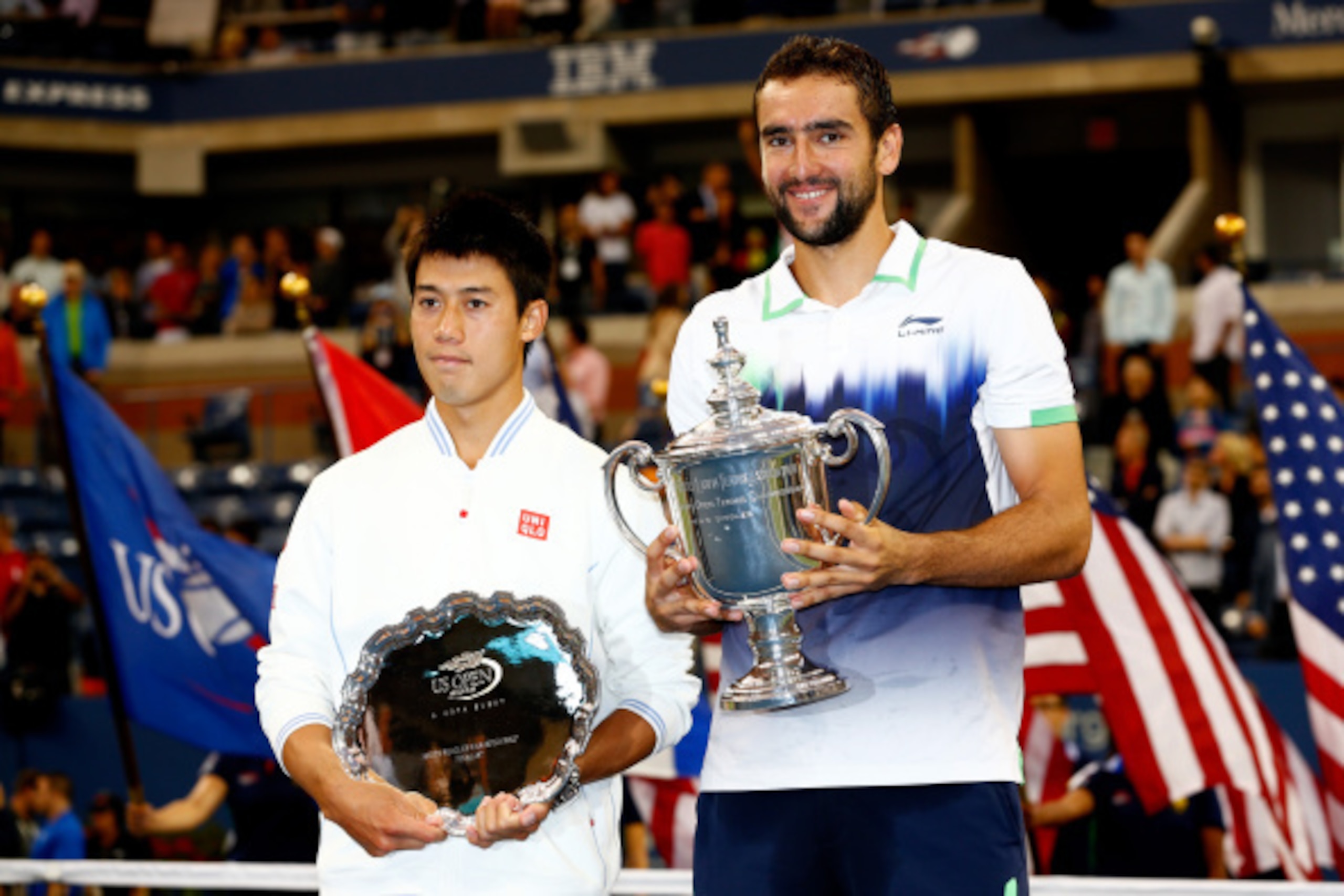 Kei Nishikori and Marin Cilic pose during the trophy ceremony at the 2014 U.S. Open. Kei Nishikori and Marin Cilic pose during the trophy ceremony at the 2014 U.S. Open.