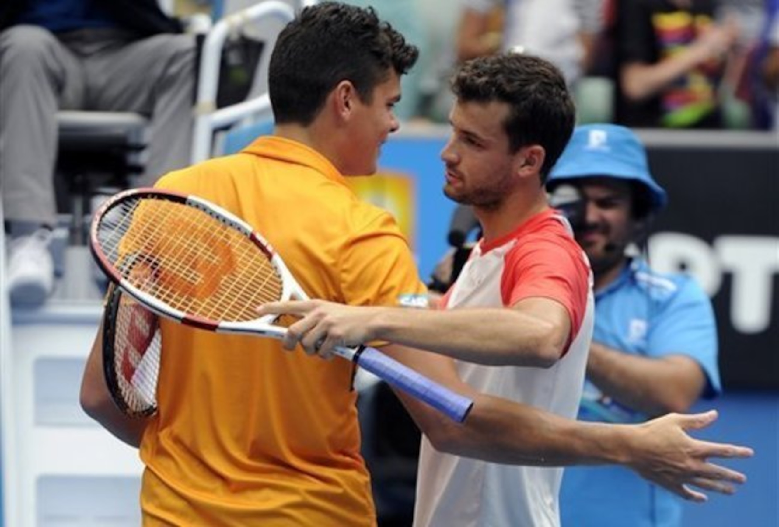 Milos Raonic embraces Grigor Dimitrov after a match at the 2014 Australian Open. Milos Raonic embraces Grigor Dimitrov after a match at the 2014 Australian Open.