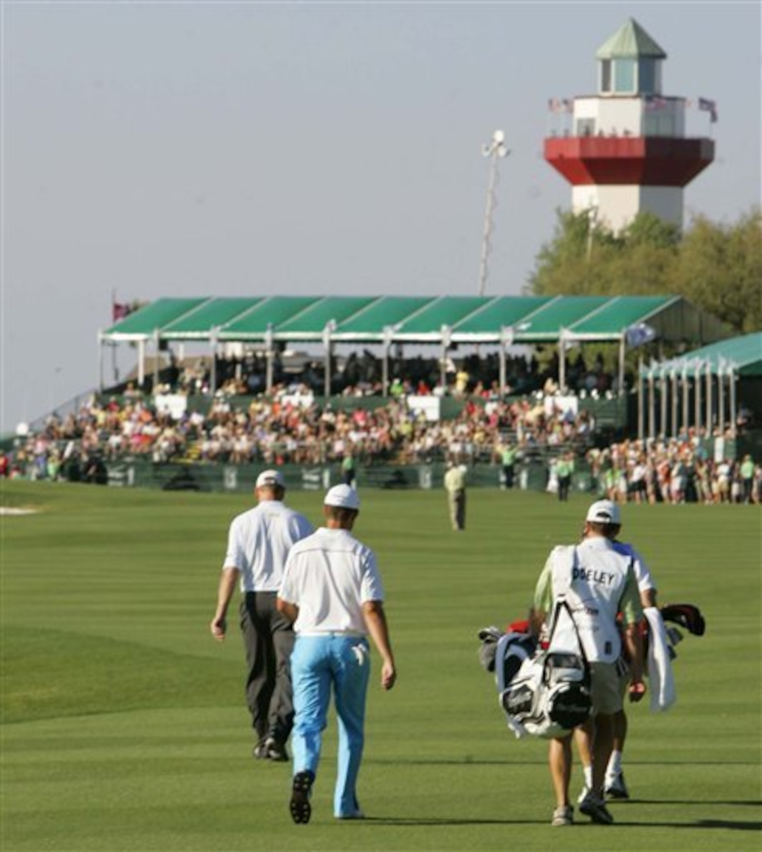 The 18th green is guarded by the red and while lighthouse.