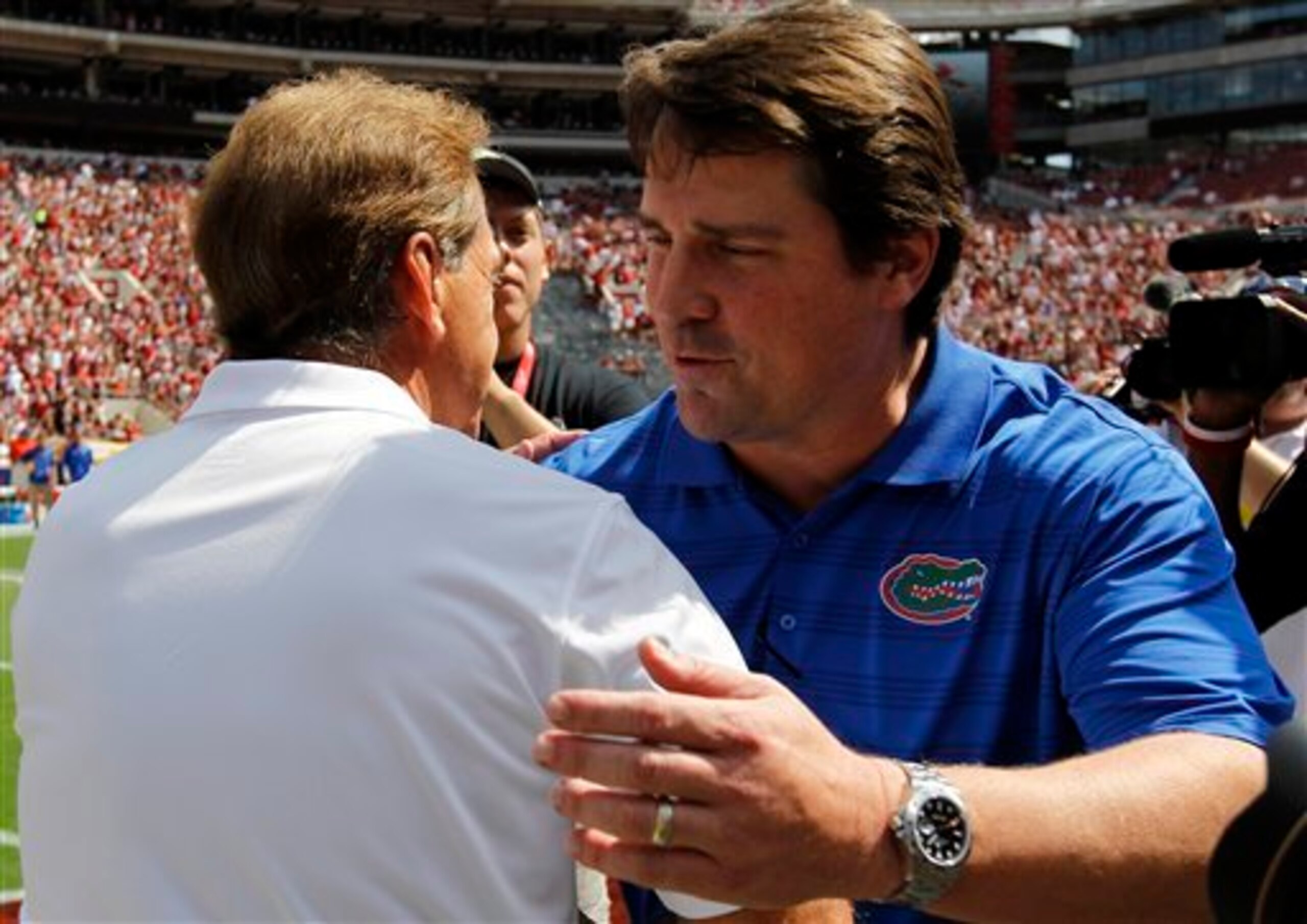 It's been a troubling season for Muschamp's (right) Gators off the field.