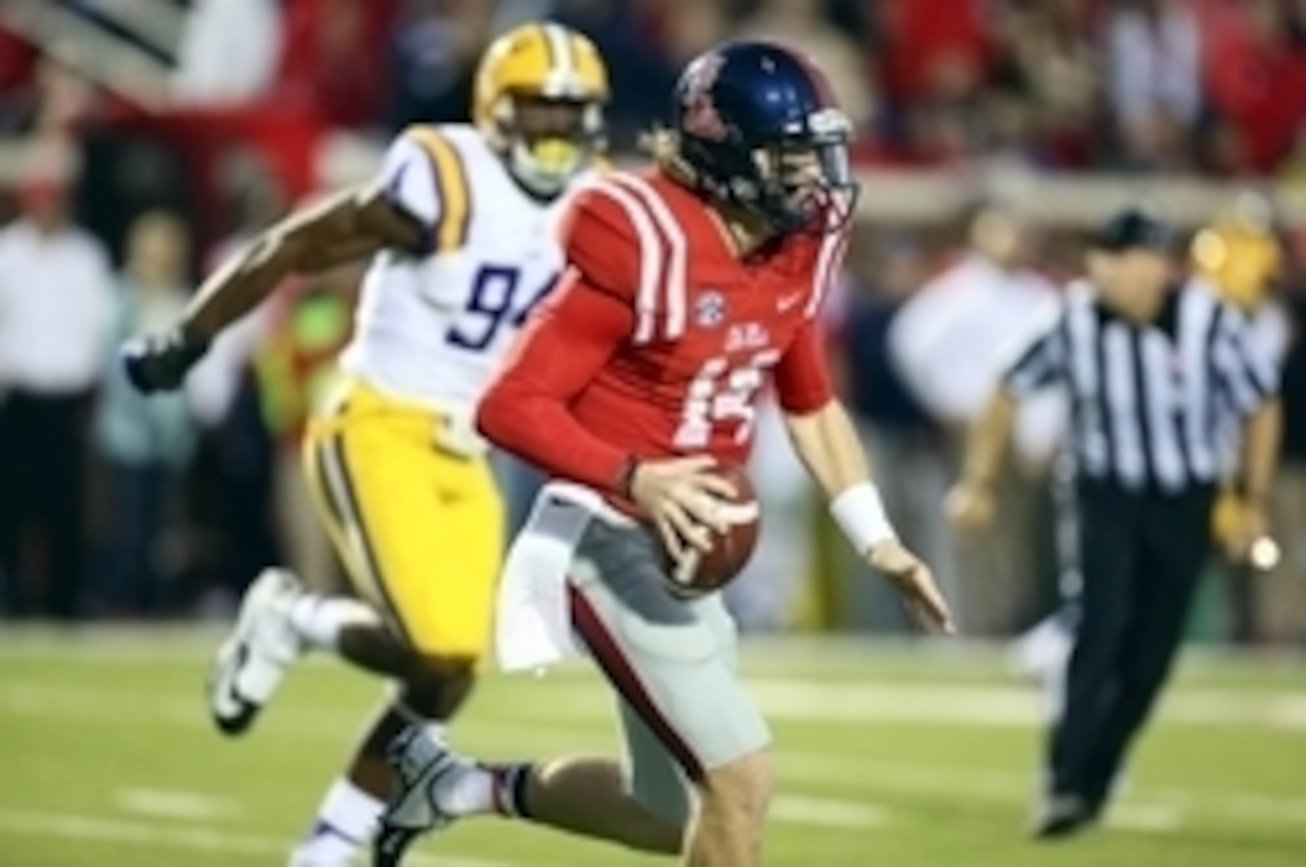 Ole Miss quarterback Bo Wallace gets chased by LSU defensive Danielle Hunter last season. The two will meet again on Saturday.