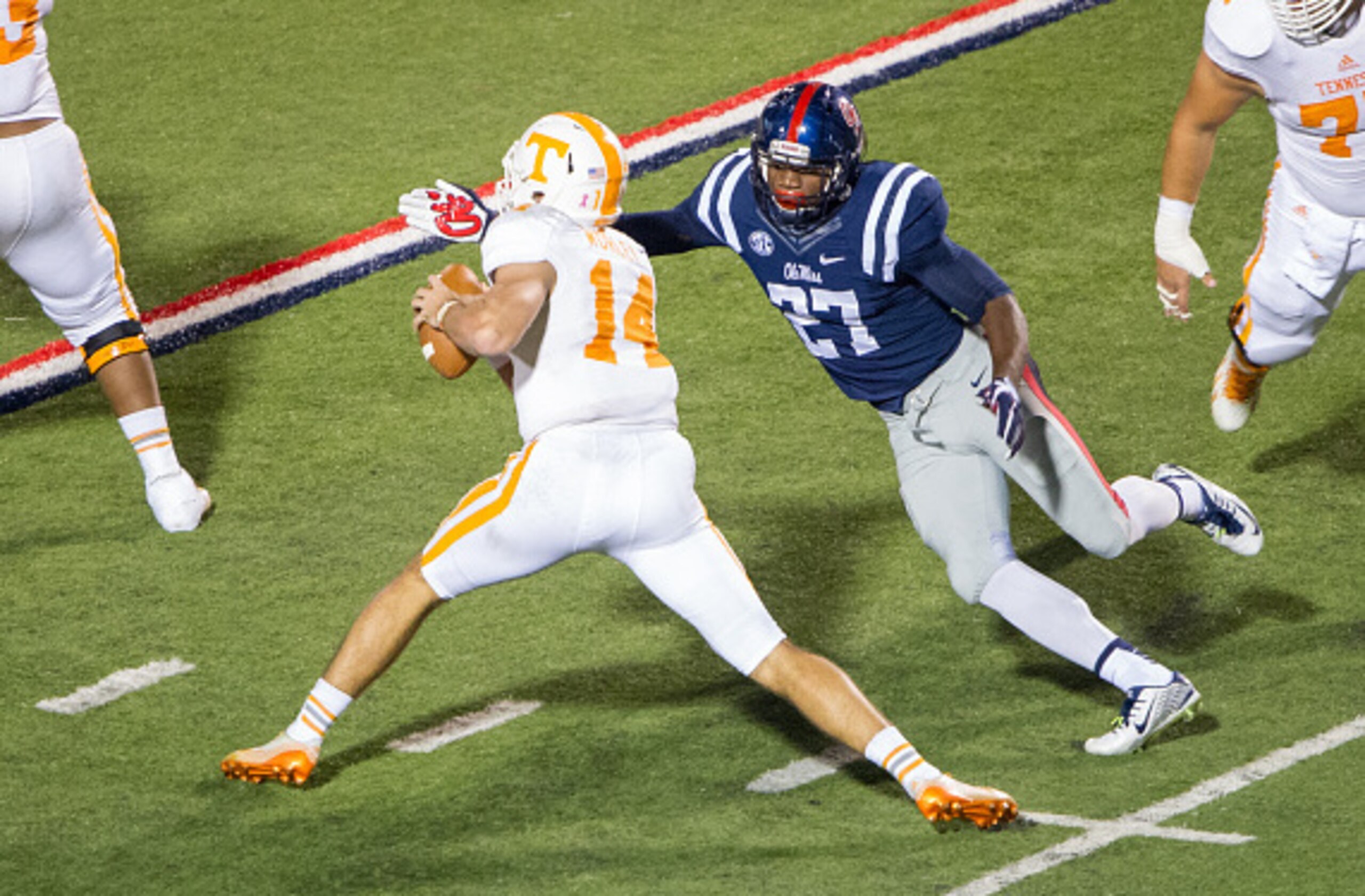 Ole Miss defensive end Marquis Haynes (No. 27) prepares to hit Tennessee quarterback Justin Worley (No. 14)