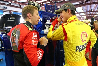 Team Penske drivers Brad Keselowski (left) and Joey Logano share a laugh.