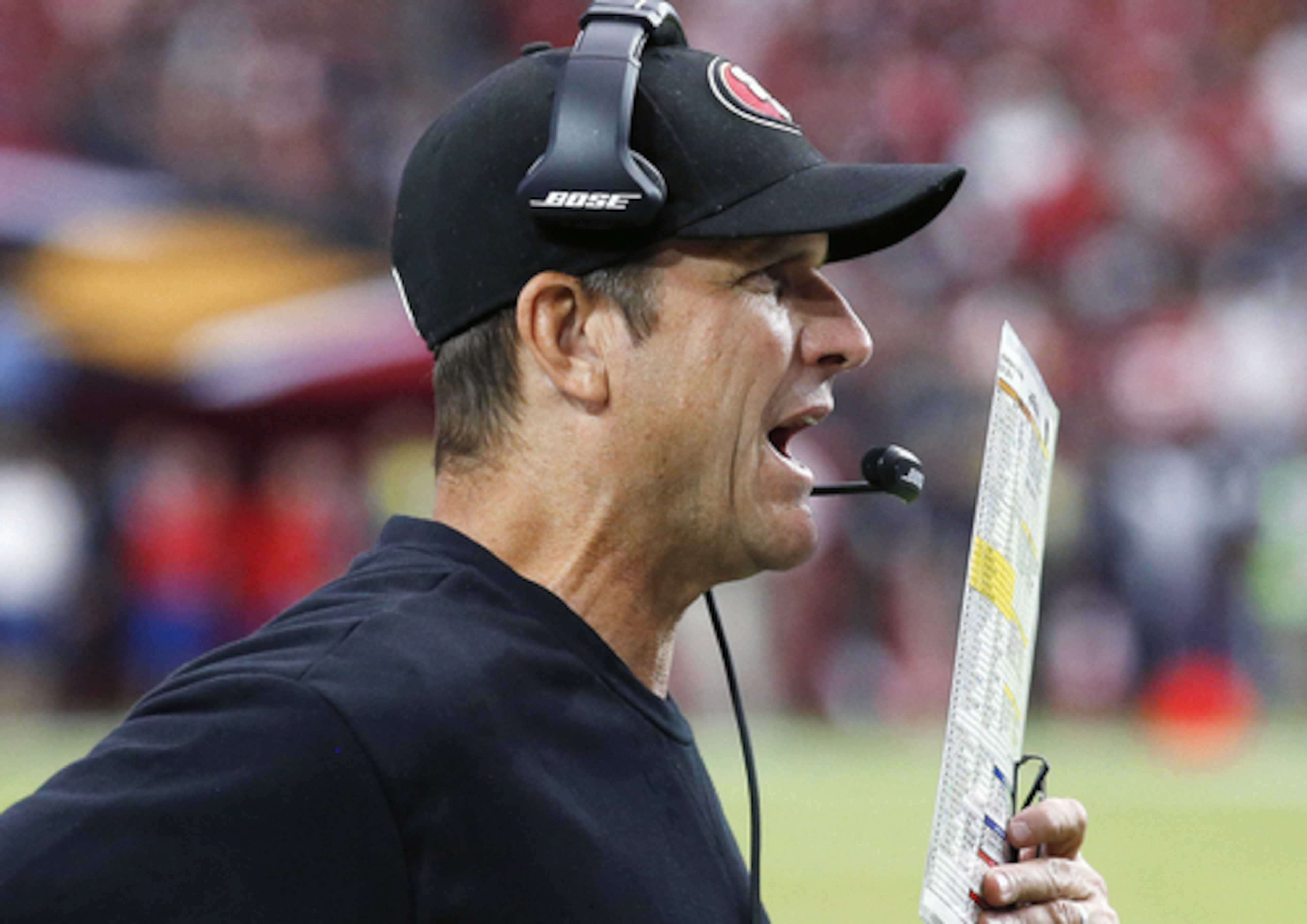 Jim Harbaugh passes the headset test.