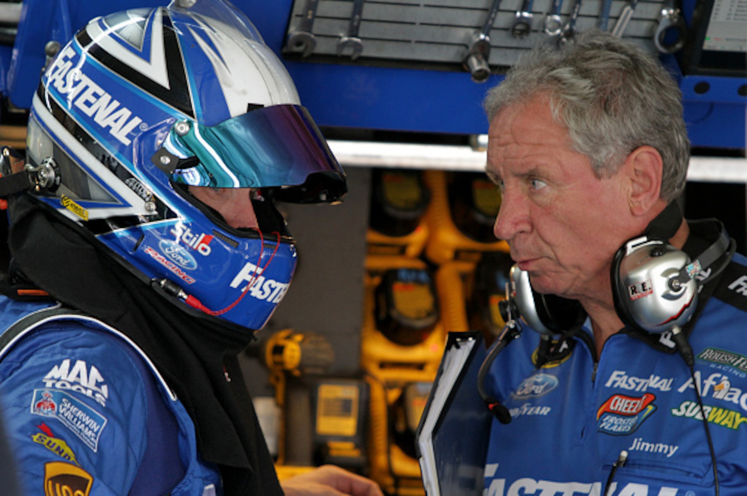 CHARLOTTE, NC - OCTOBER 10:  Carl Edwards, driver of the #99 Fastenal Ford, left, talks with crew chief Jimmy Fennig in the garage area during practice for the NASCAR Sprint Cup Series Bank of America 500 at Charlotte Motor Speedway on October 10, 2014 in