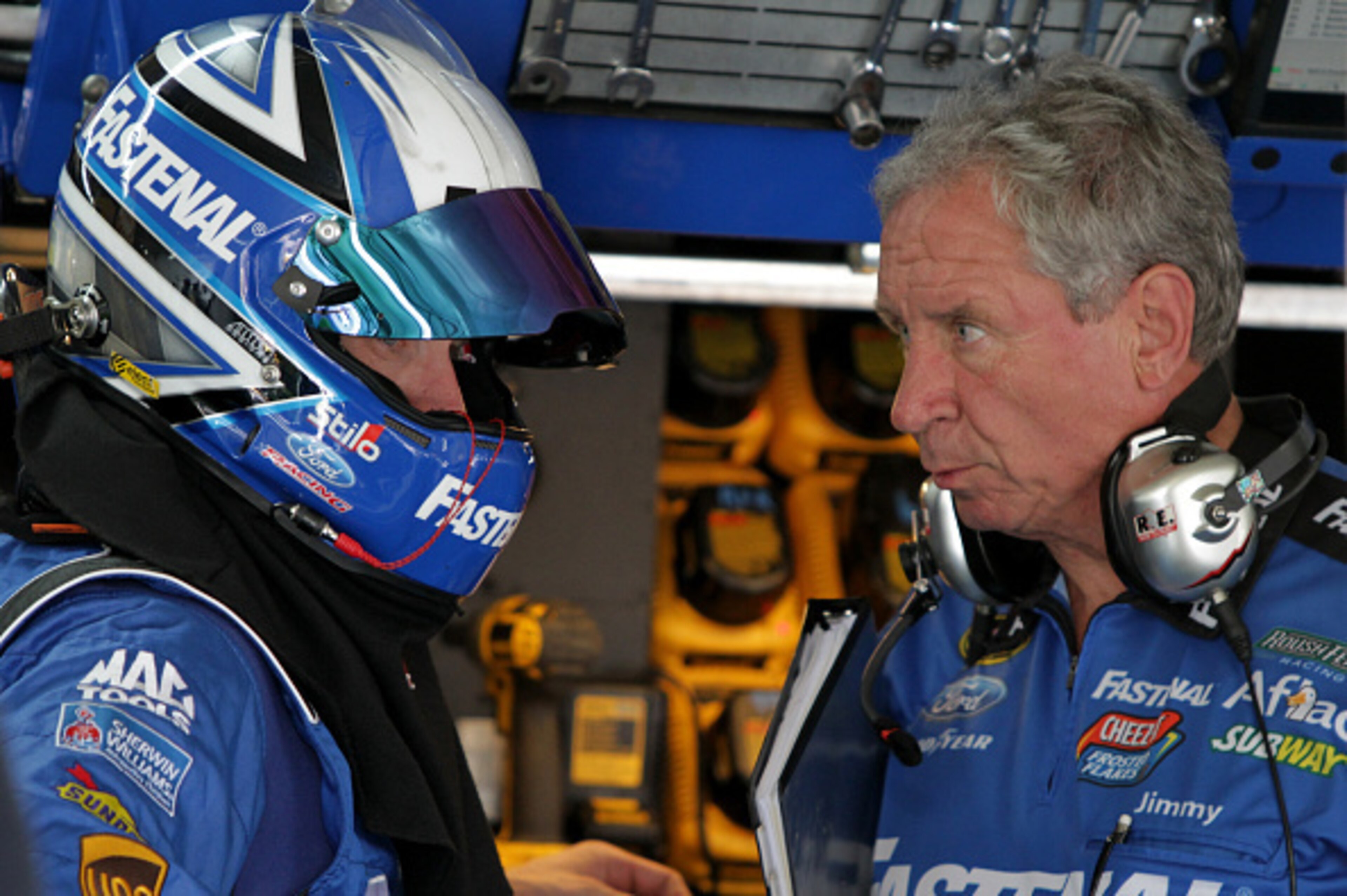 CHARLOTTE, NC - OCTOBER 10:  Carl Edwards, driver of the #99 Fastenal Ford, left, talks with crew chief Jimmy Fennig in the garage area during practice for the NASCAR Sprint Cup Series Bank of America 500 at Charlotte Motor Speedway on October 10, 2014 in