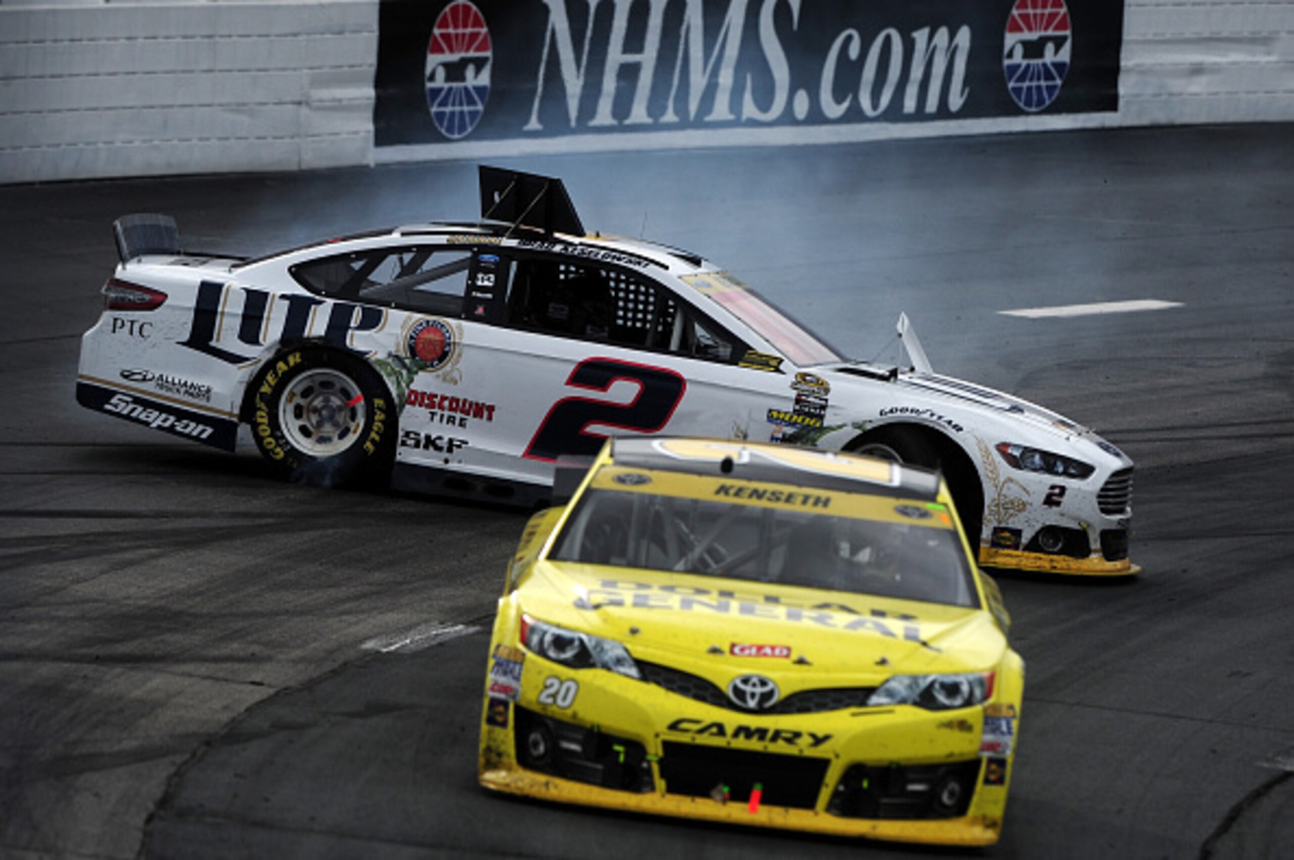 LOUDON, NH - SEPTEMBER 21:  Brad Keselowski, driver of the #2 Miller Lite Ford, loses control of the car after making contact with Matt Kenseth, driver of the #20 Dollar General Toyota, during the NASCAR Sprint Cup Series Sylvania 300 at New Hampshire Mot