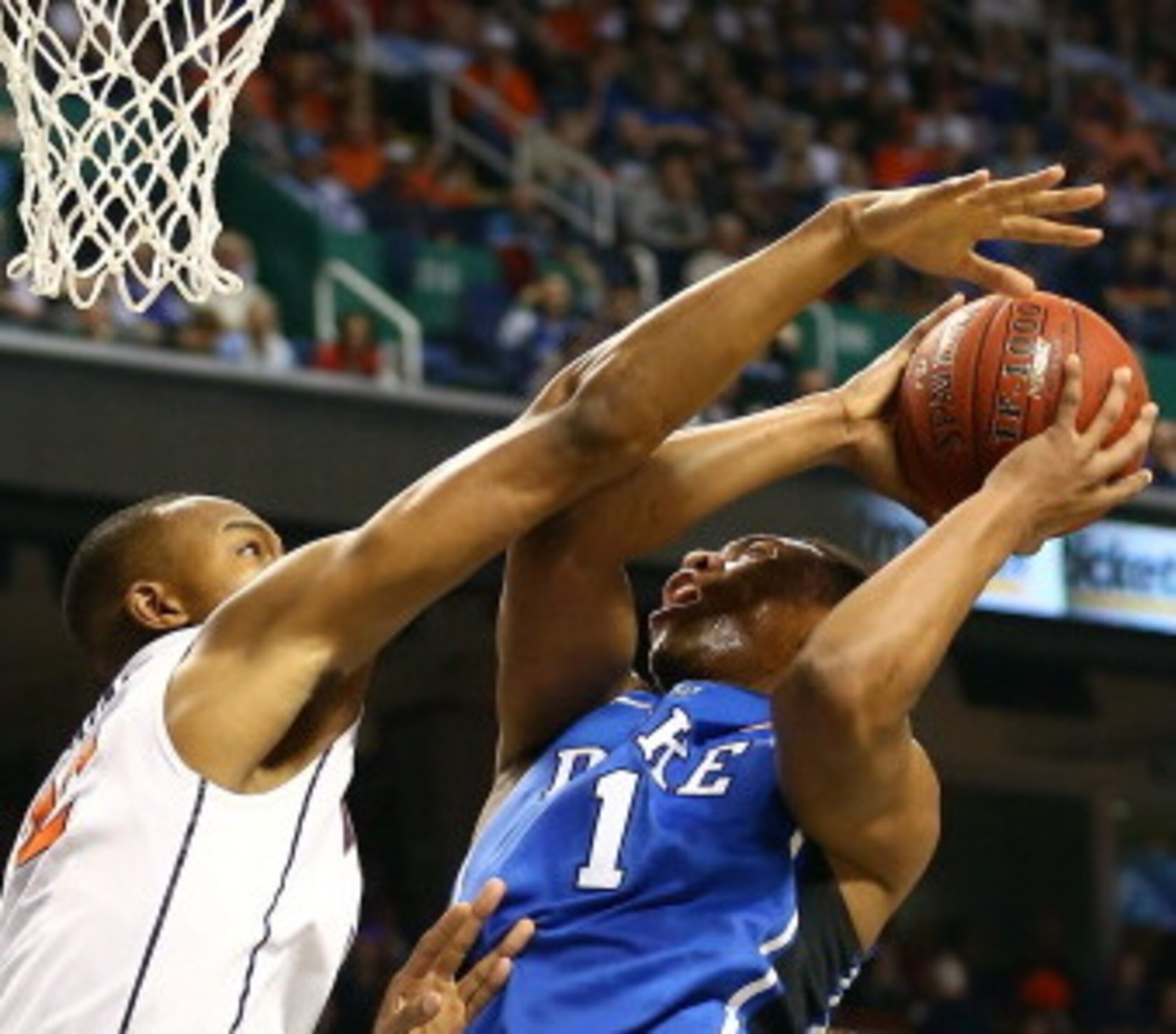 GREENSBORO, NC - MARCH 16:  Darion Atkins #32 of the Virginia Cavaliers fouls Jabari Parker #1 of the Duke Blue Devils as he goes up for a shot during the finals of the 2014 Men's ACC Basketball Tournament at Greensboro Coliseum on March 16, 2014 in Green