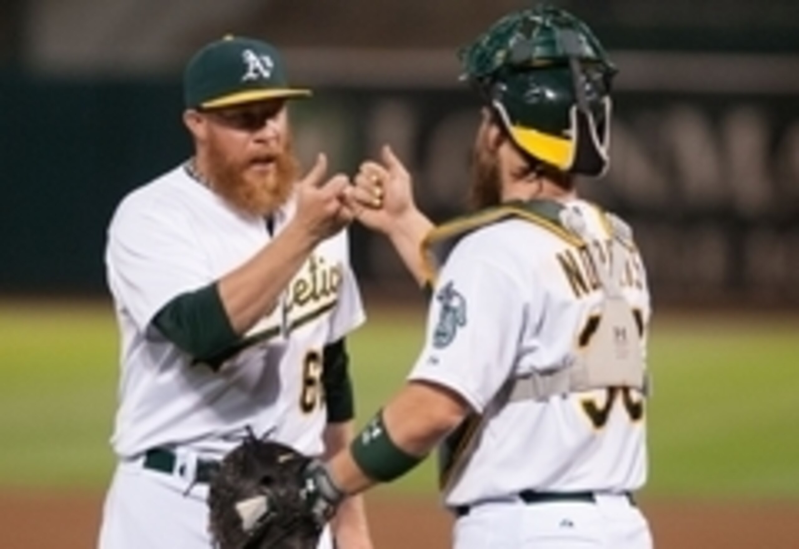 Sep 19, 2014; Oakland, CA, USA; Oakland Athletics relief pitcher Sean Doolittle (62) and catcher Derek Norris (36) celebrate after defeating the Philadelphia Phillies 3-1 at O.co Coliseum. Mandatory Credit: Ed Szczepanski-USA TODAY Sports