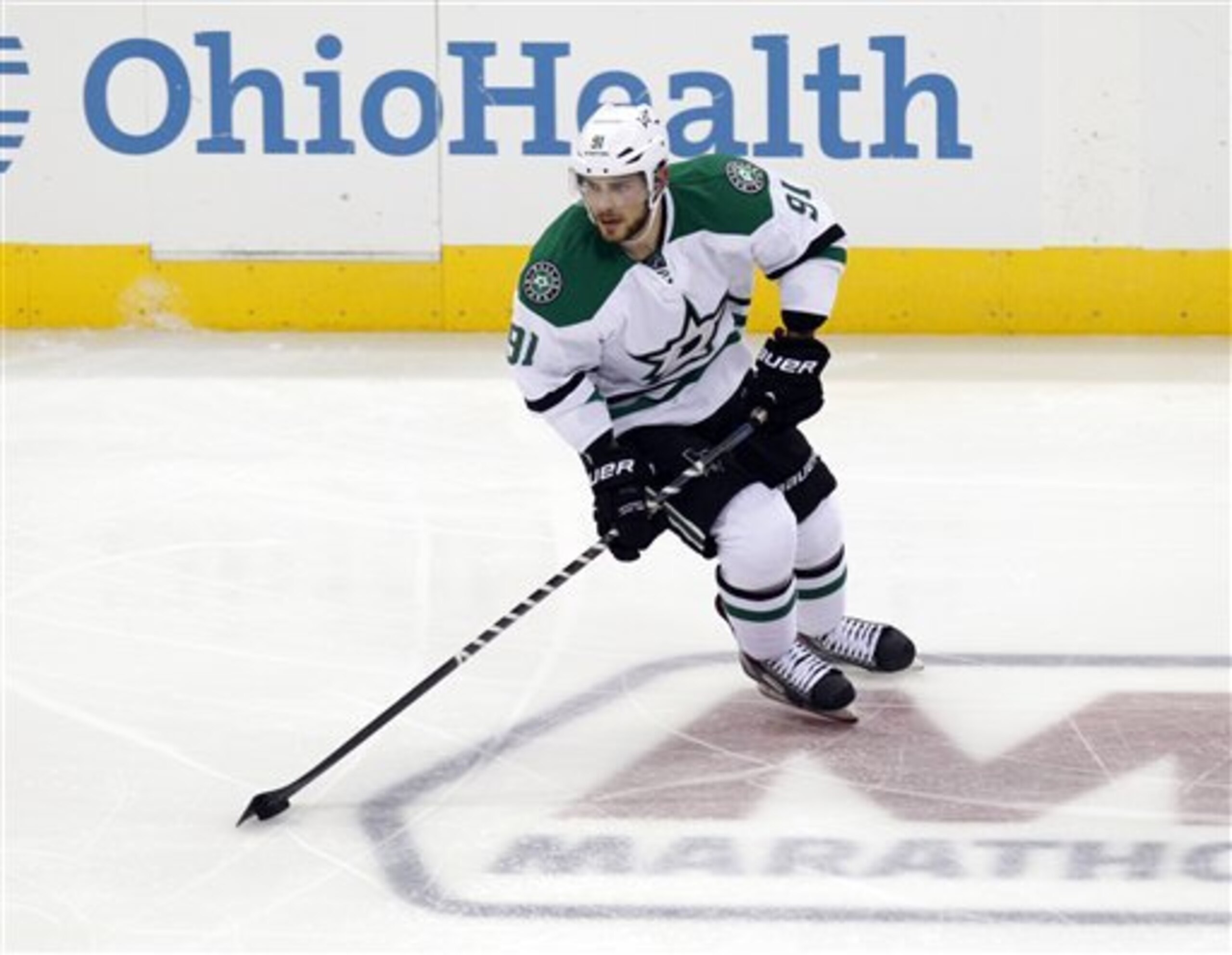 Dallas Stars' Tyler Seguin carries the puck up  ice against the Columbus Blue Jackets during an NHL hockey game in Columbus, Ohio, Tuesday, Oct. 14, 2014. (AP Photo/Paul Vernon)
