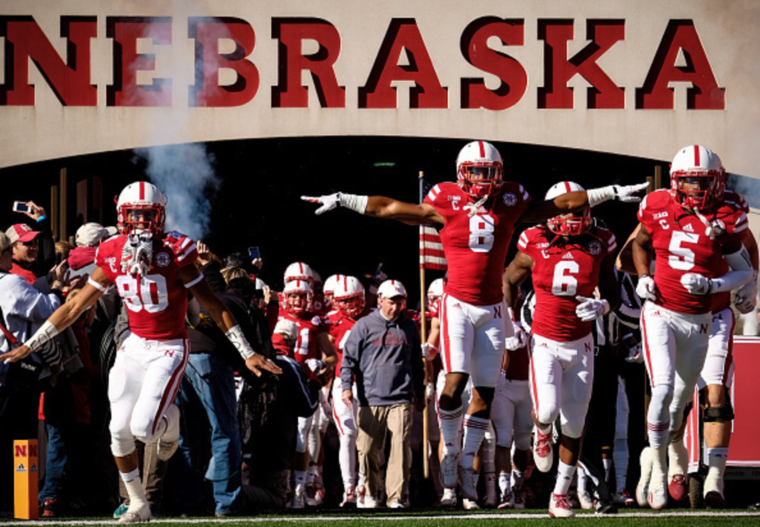 LINCOLN, NE - NOVEMBER 1: Wide receiver Kenny Bell, running back Ameer Abdullah and cornerback Josh Mitchell #5 of the Nebraska Cornhuskers lead the captains on the field before their game against the Purdue Boilermakers at Memorial Stadium on November 1,