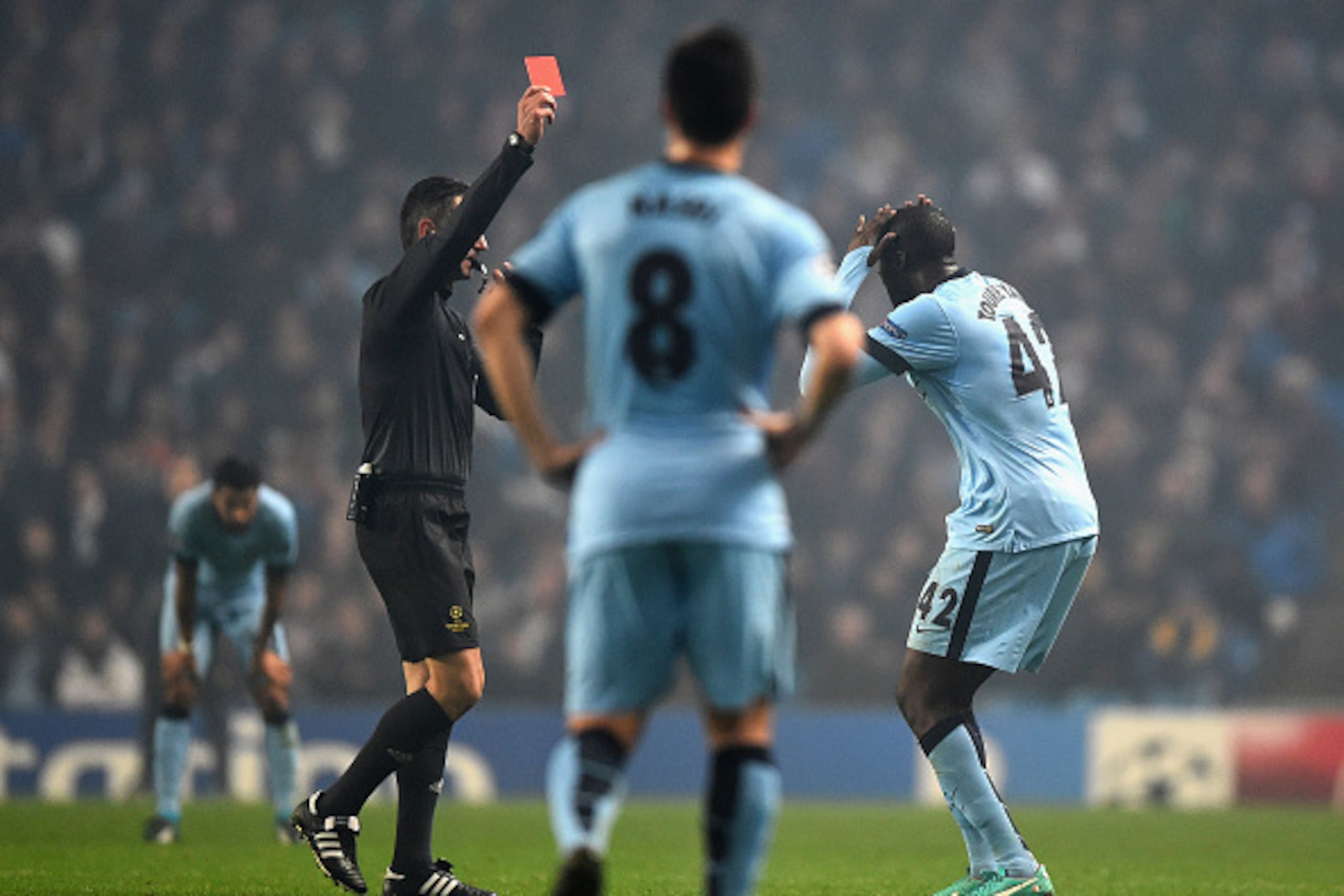 This image is perfect -- Toure doing something dumb while Nasri stands there doing nothing.